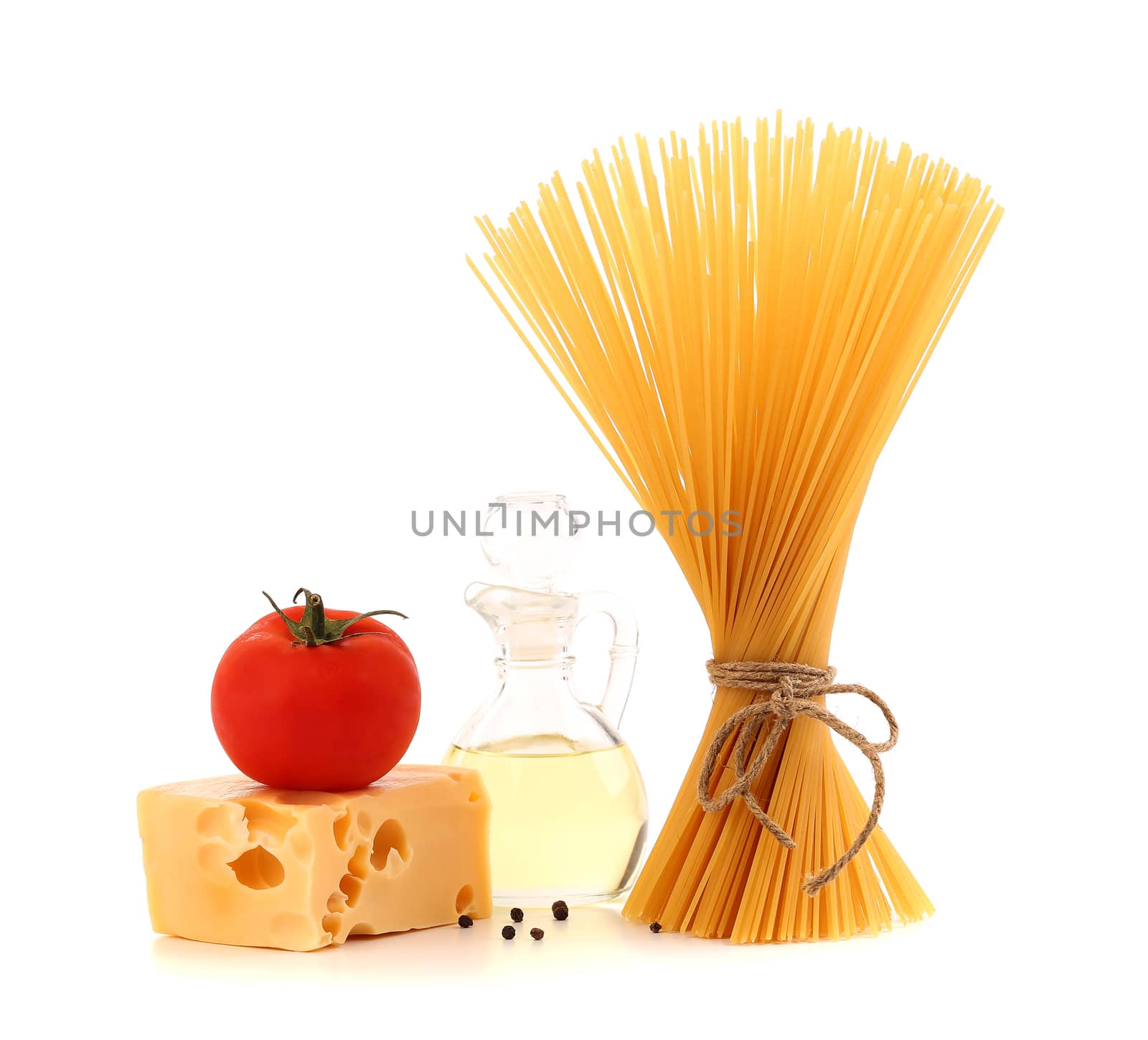 Bunch of spaghetti pasta, fresh tomatoes, cheese, bottle of oil and pepper by indigolotos