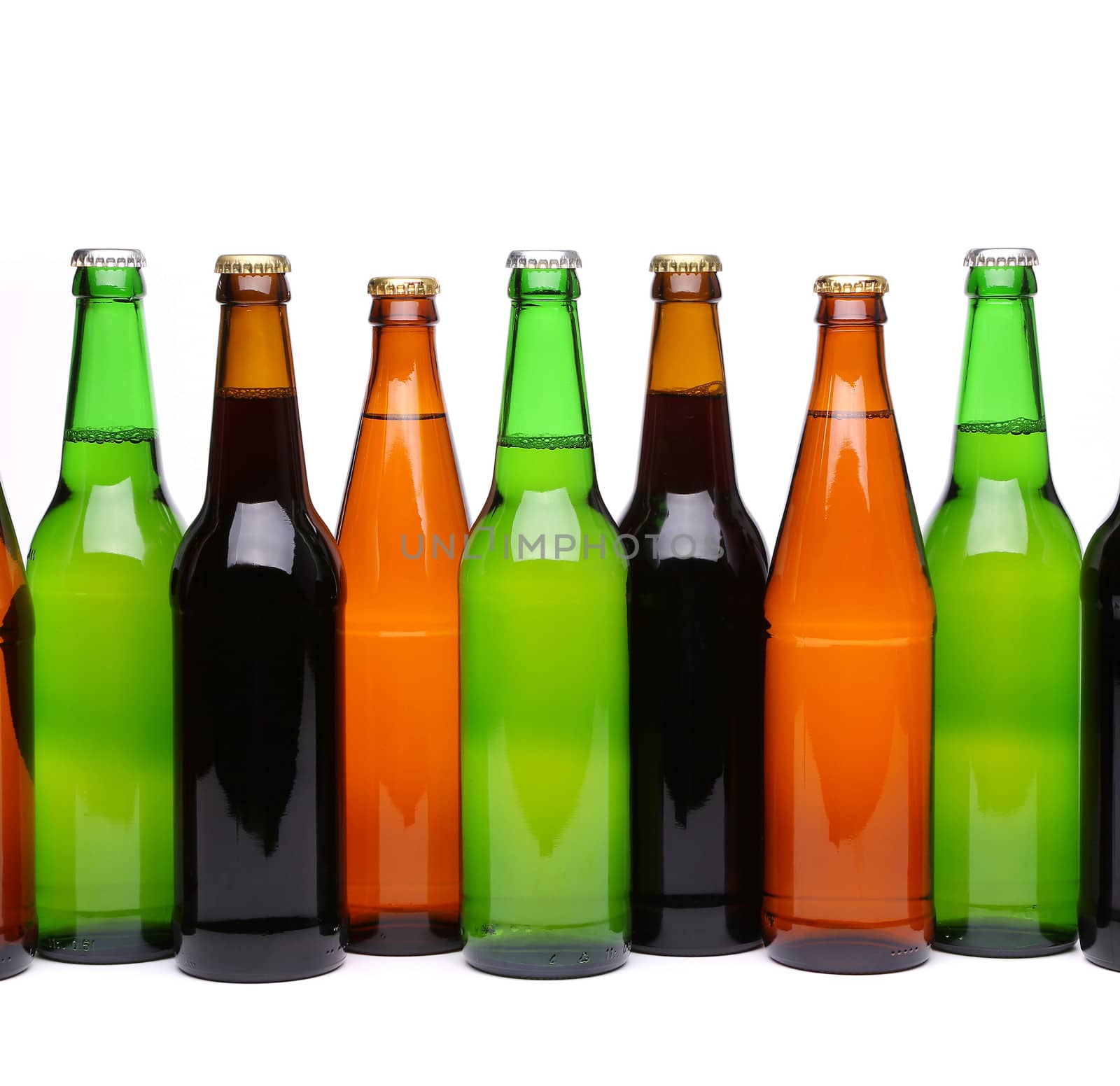 Different bottles of beer in row on the white background