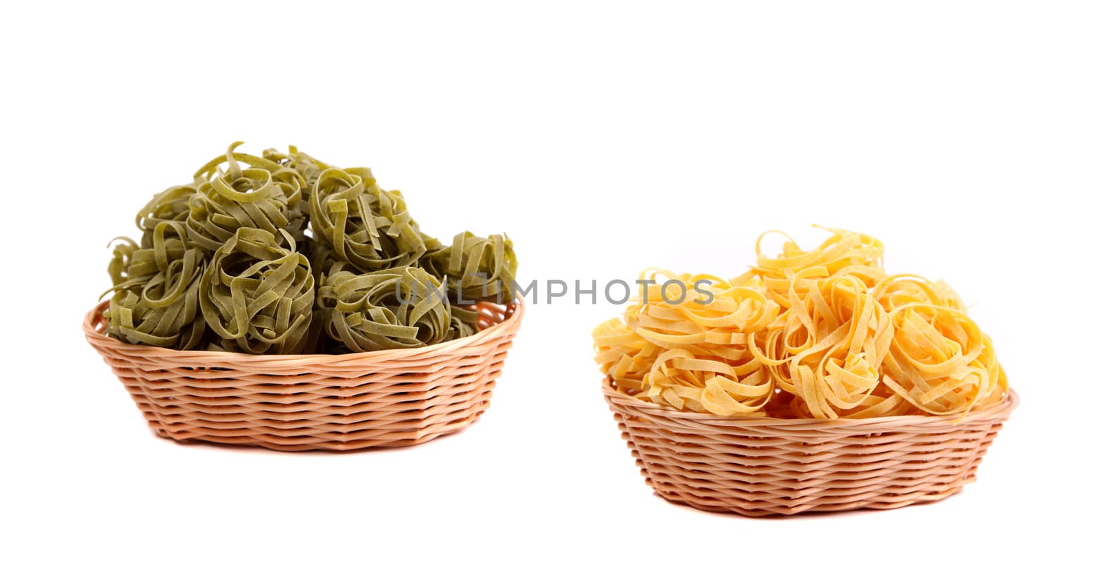 Tagliatelle paglia e fieno at round woven straw baskets on the white background.