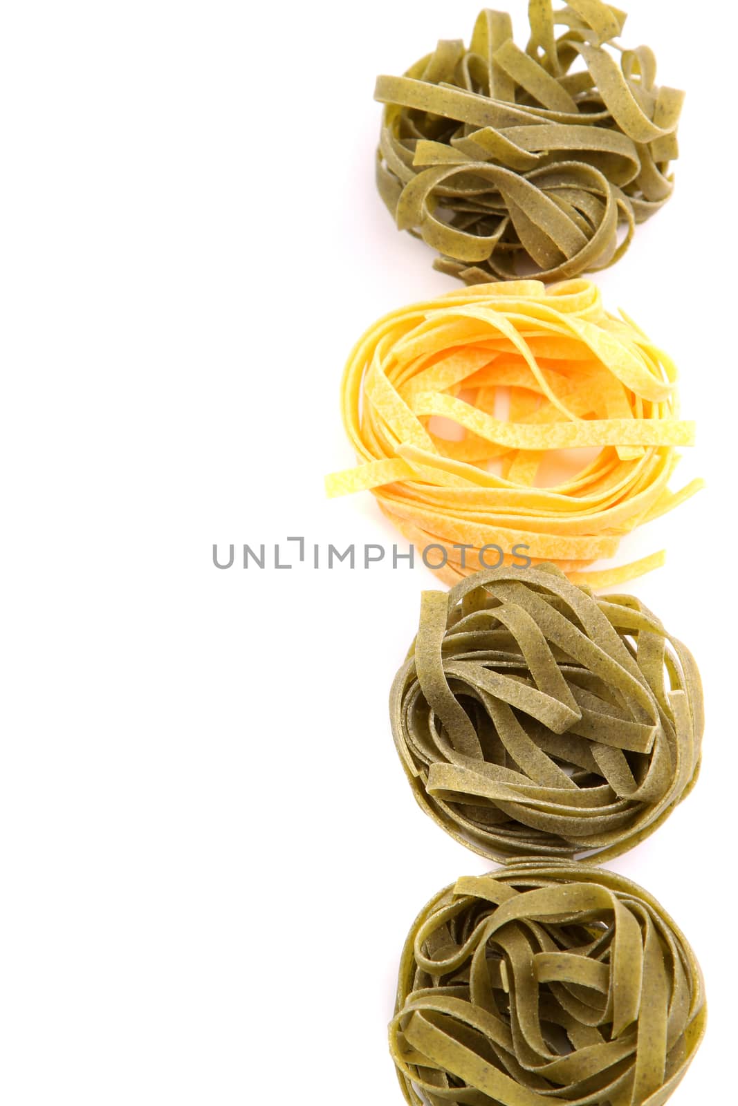 Tagliatelle paglia e fieno homemade tipycal italian pasta close-up. by indigolotos