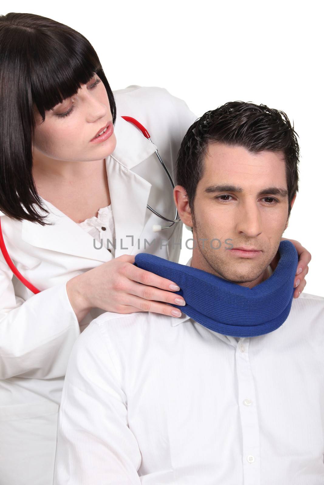 Doctor putting a neck brace on her patient by phovoir