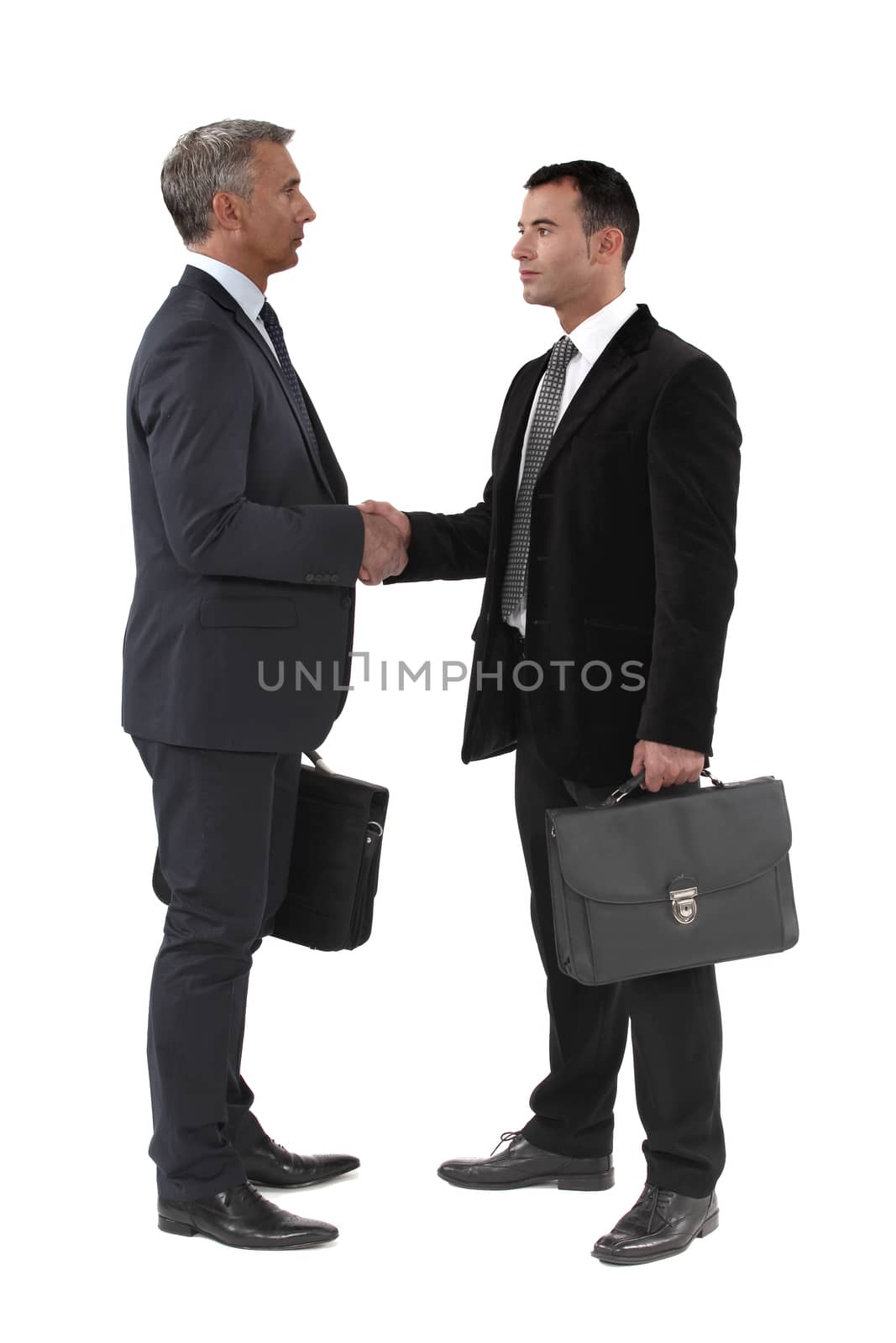 Businessmen shaking hands by phovoir