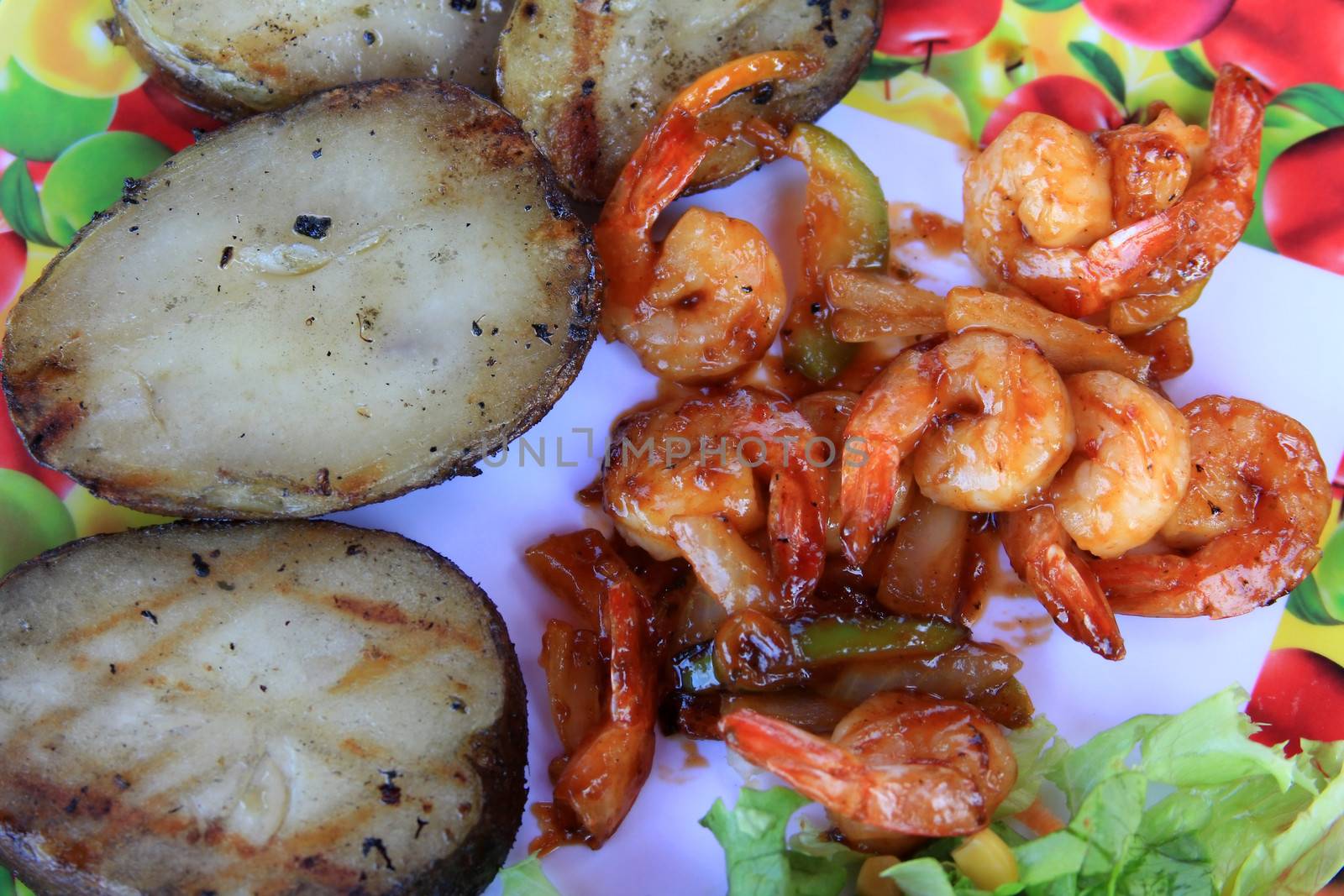 prawn in sweet red sauce with a potato and vegetables