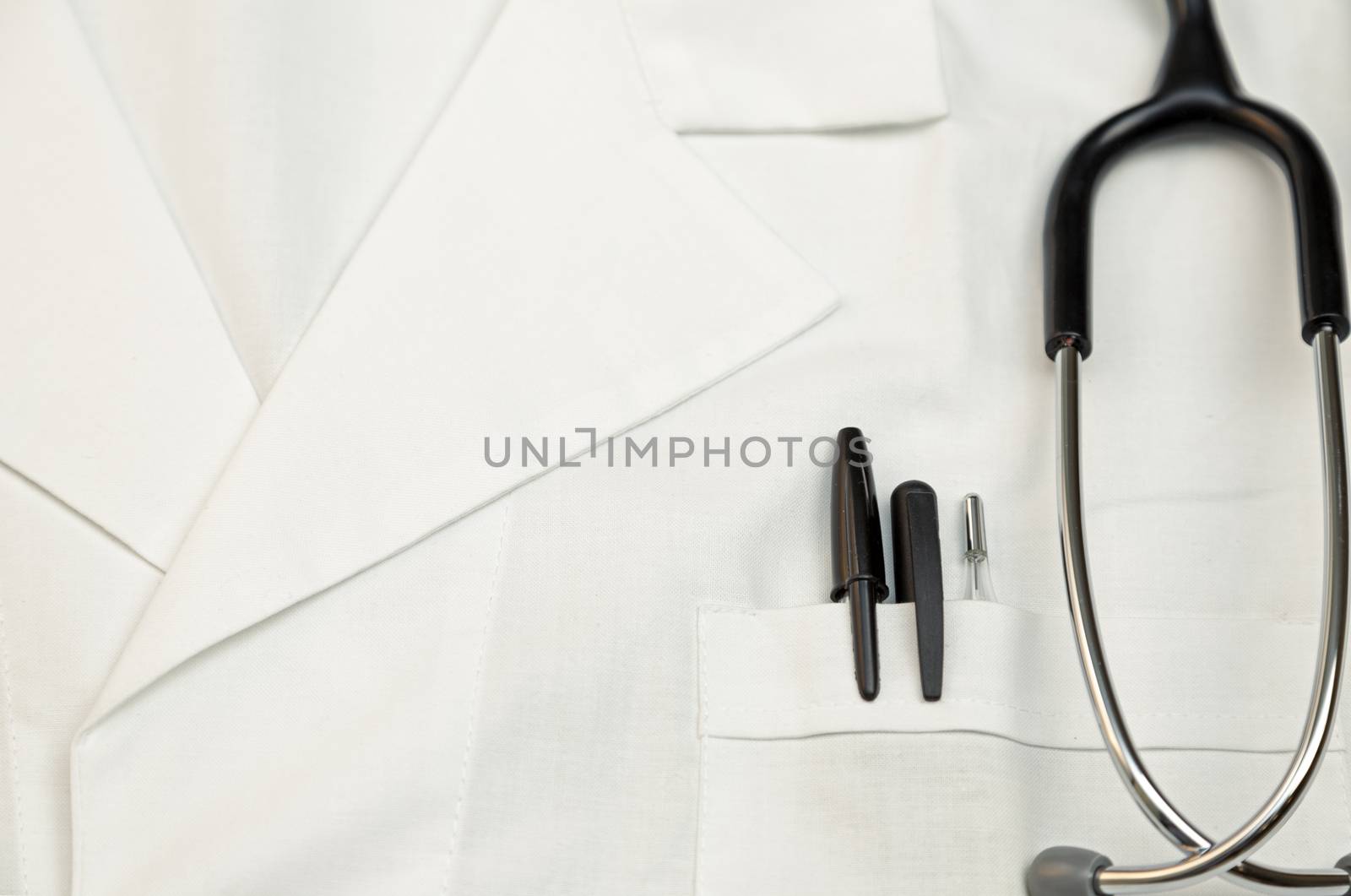 Doctor scrubs with stethoscope, thermometer and pens in the pocket.