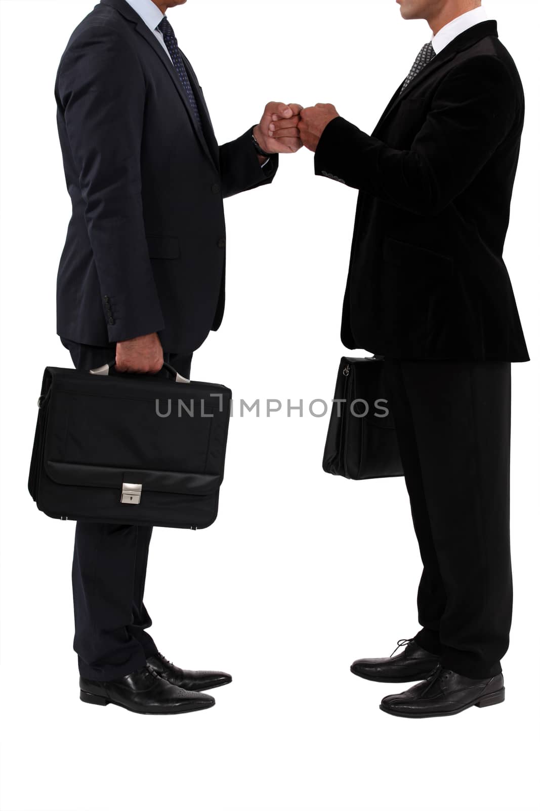 Two businessmen bumping fists