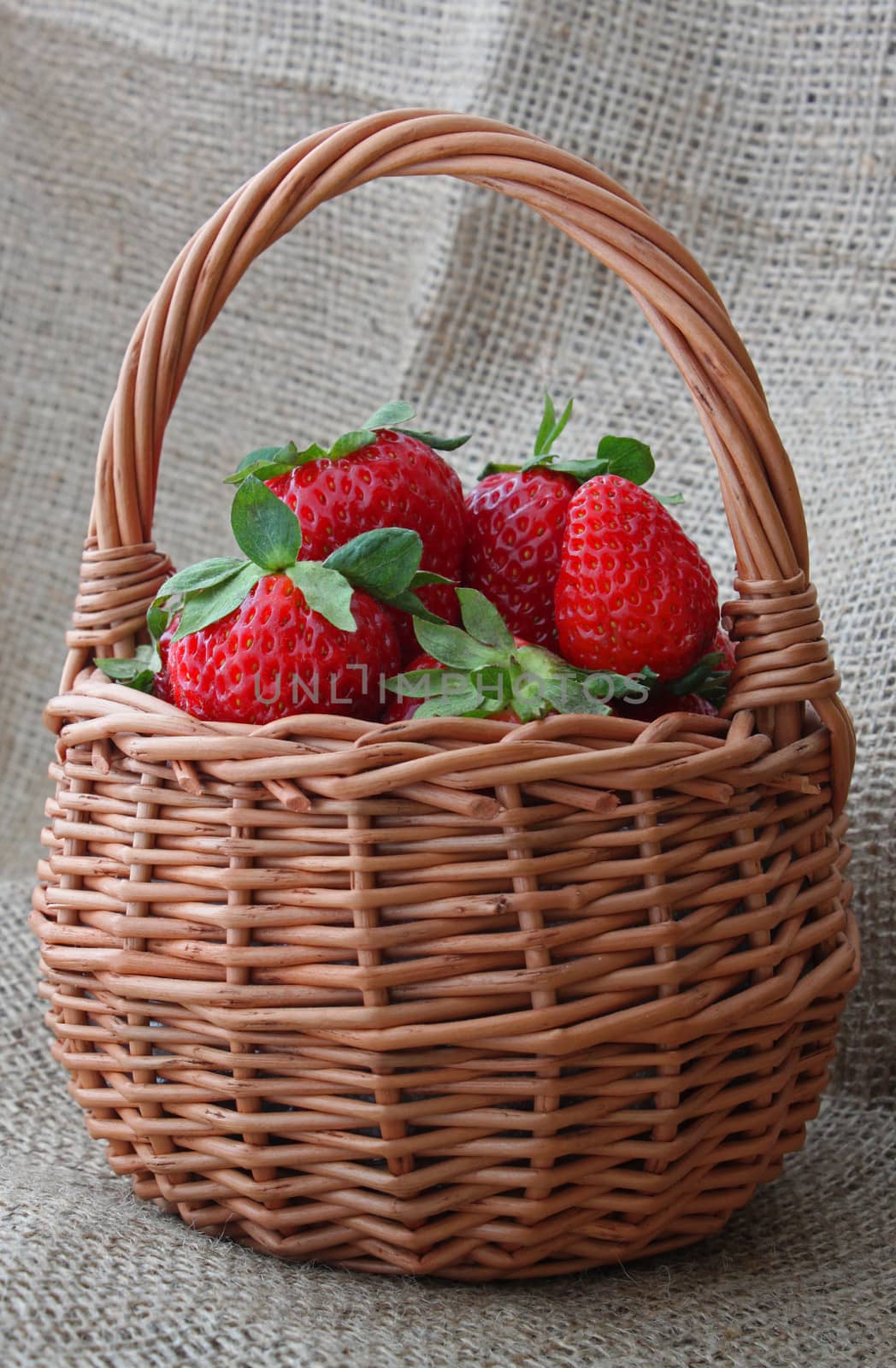 strawberry in a wicker basket on fabric