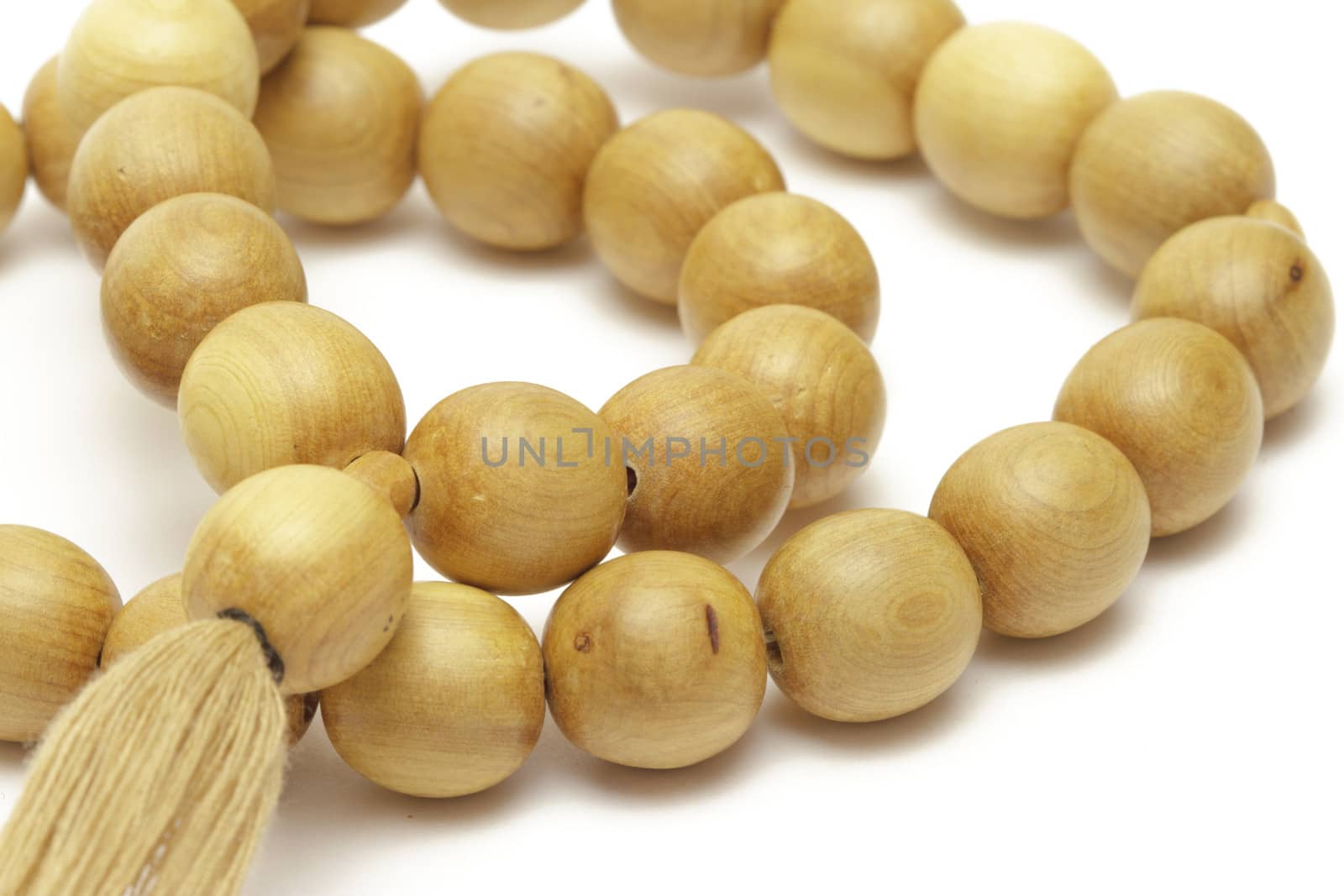 Wooden rosary on white background