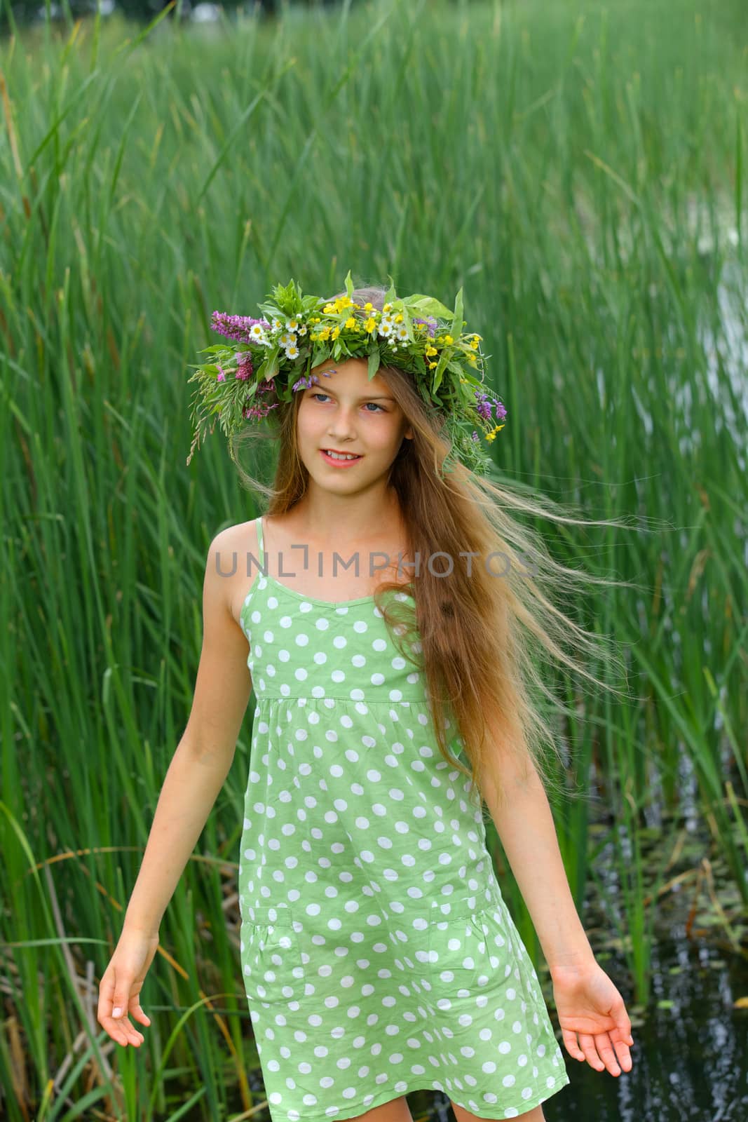 Spring portrait beautiful girl with wreath of flowers