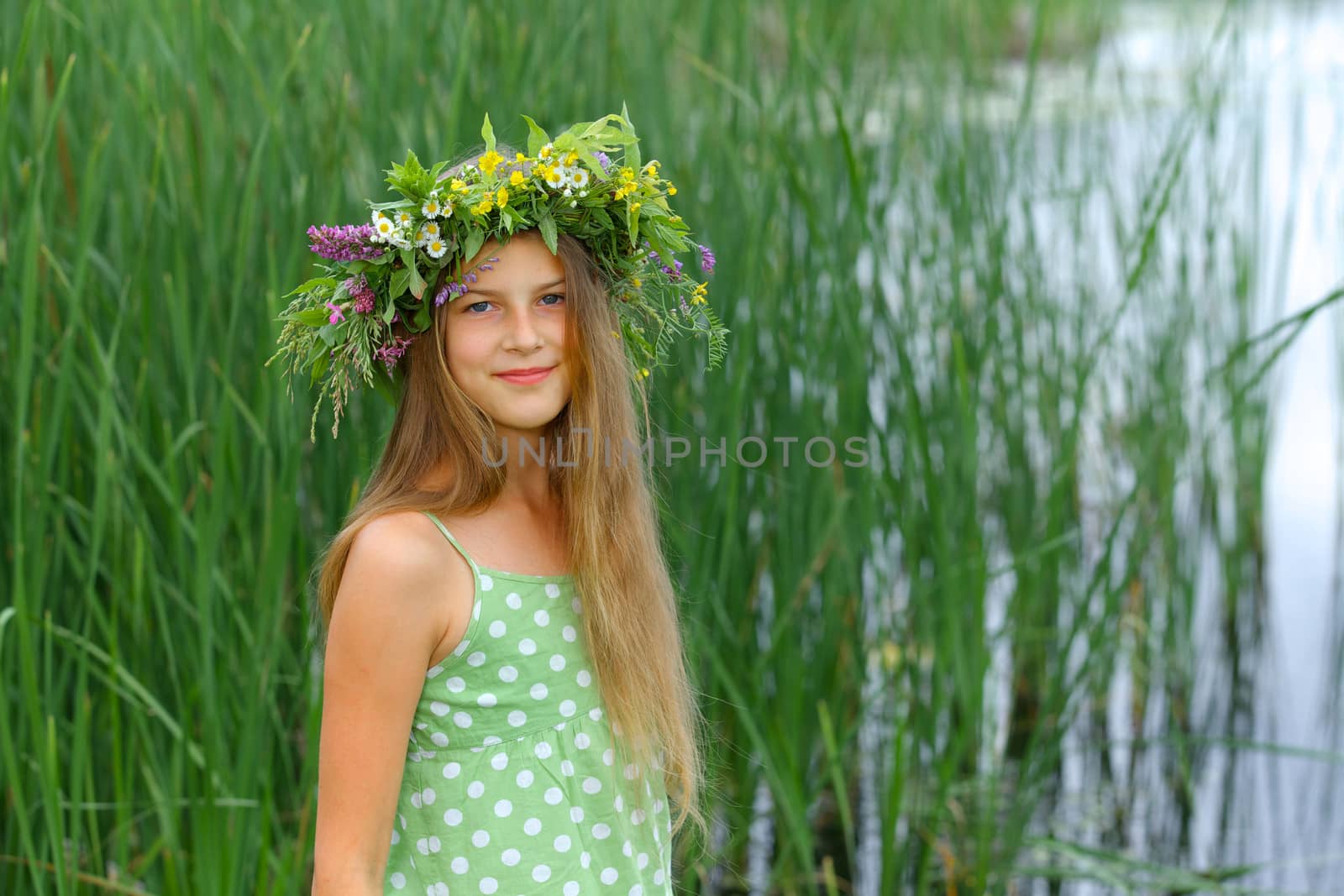 Spring portrait beautiful girl with wreath of flowers