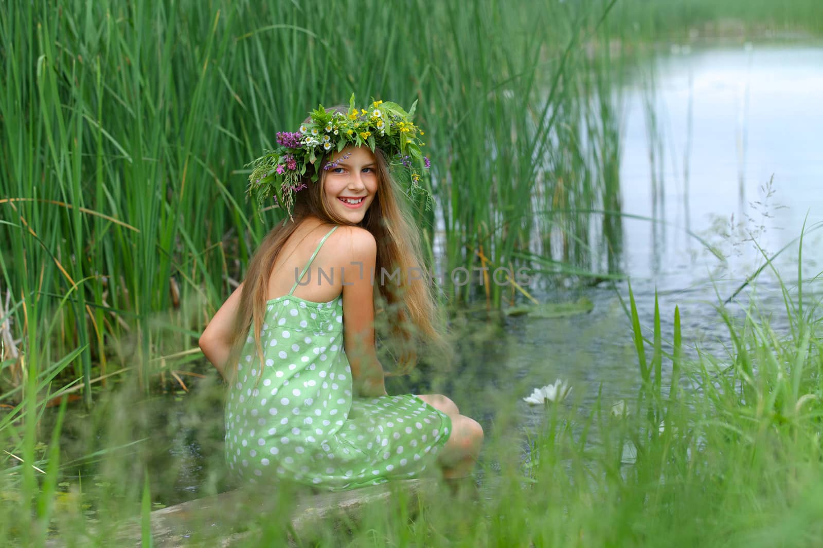 Spring portrait beautiful girl with wreath of flowers