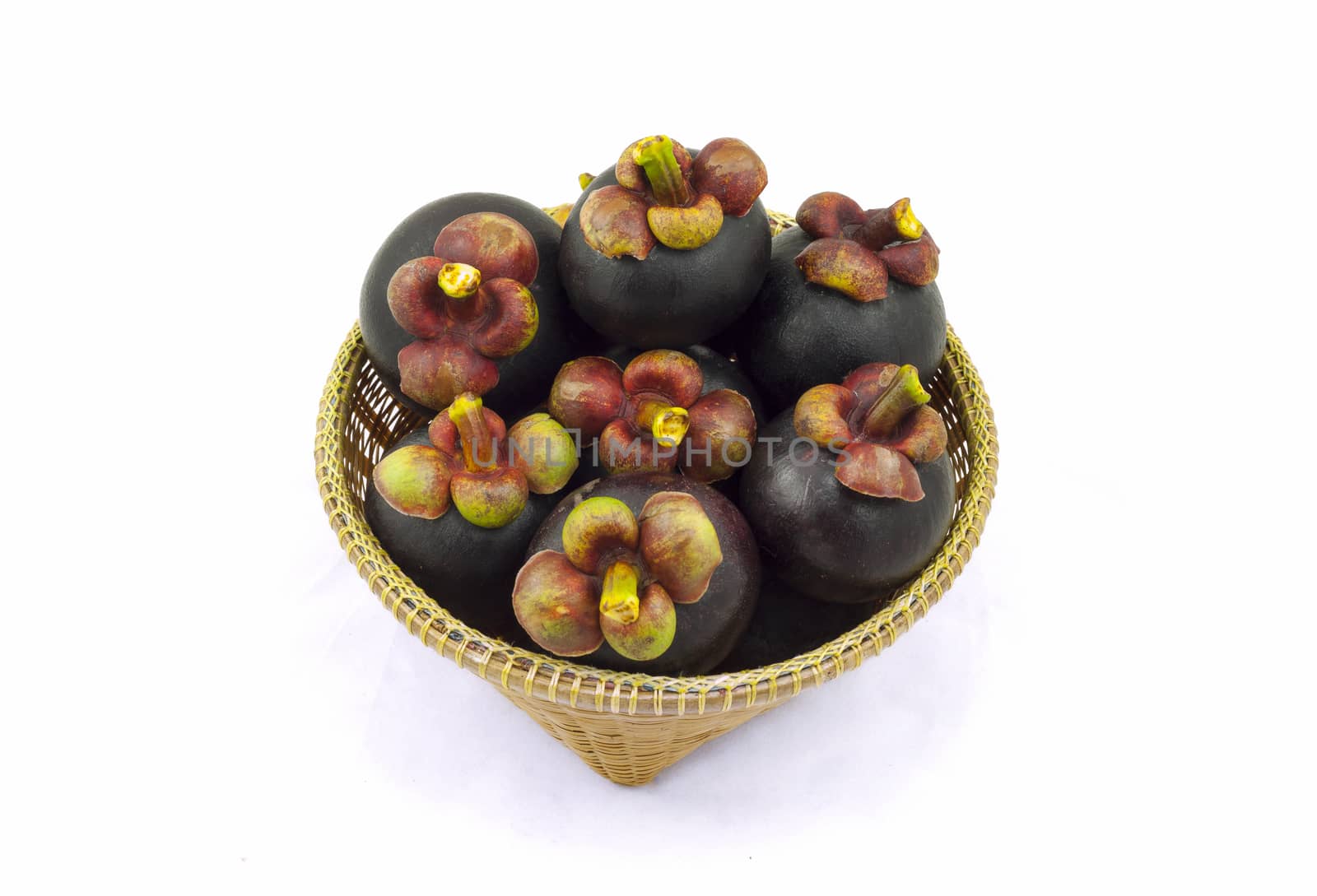 Mangosteen Thai fruit  in wicker basket isolated on white background.