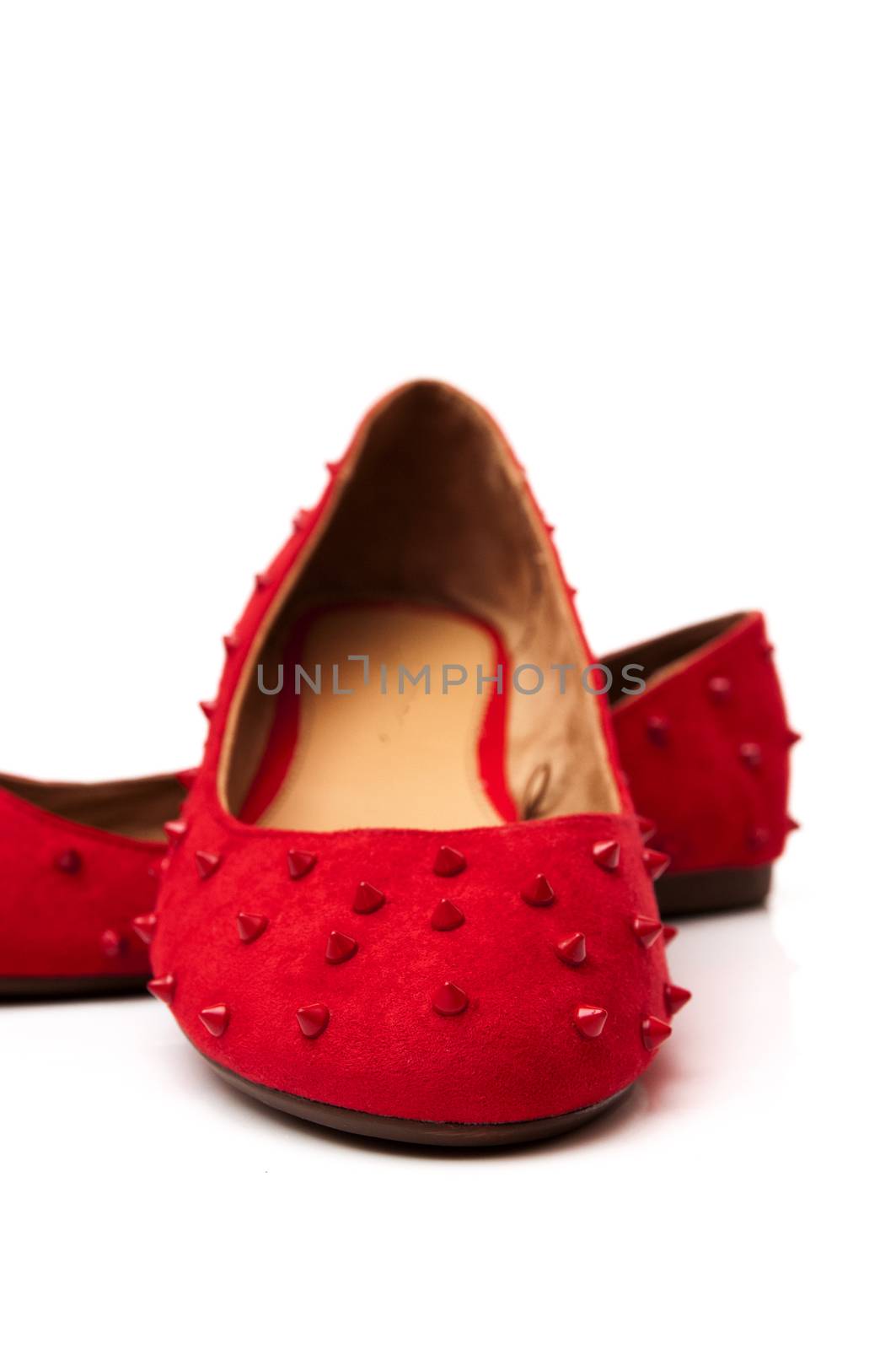 Spiked red shoes on a white background