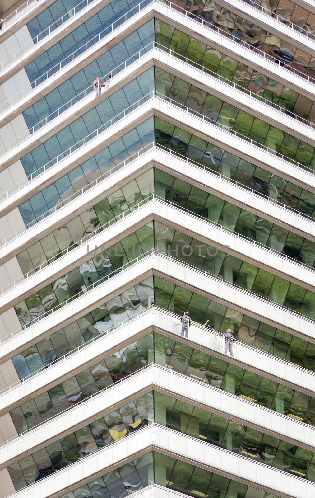 Group of workers cleaning windows on a skyscraper building
