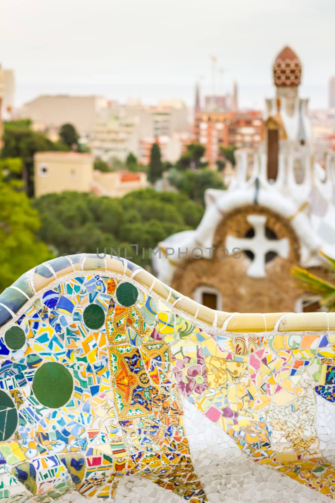 Closeup of colorful ceramic mosaic in a bench of park Guell, designed by Antonio Gaudi, in Barcelona, Spain