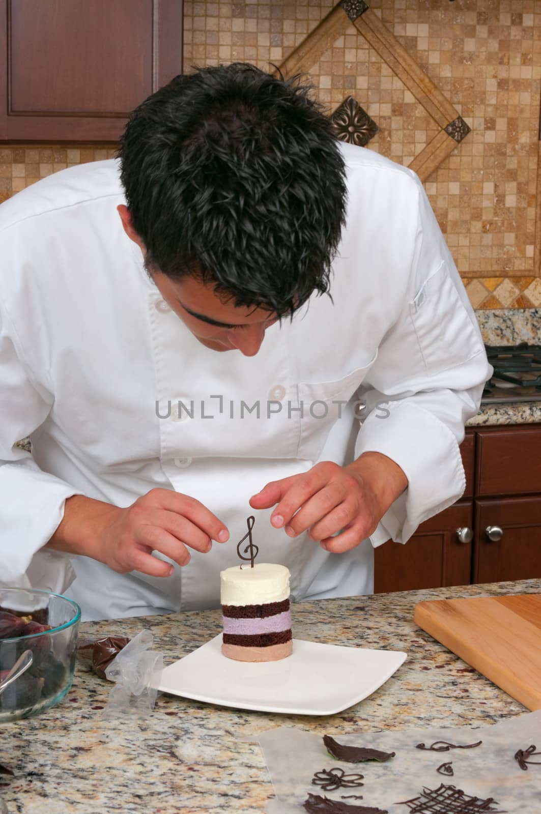 Chef making mousse cake and decorating