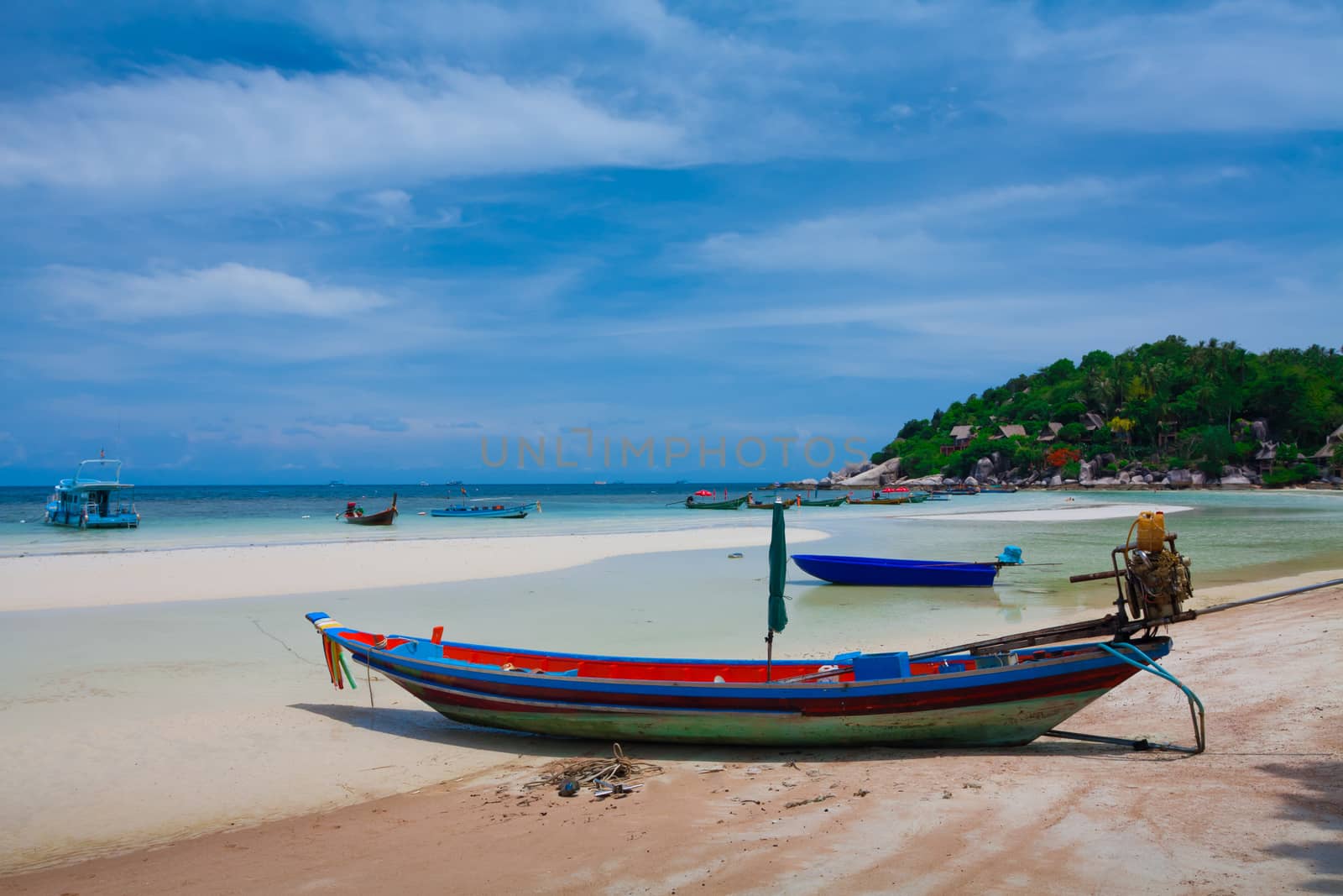 Tropical beach, traditional long tail boats and the sea south of Thailand