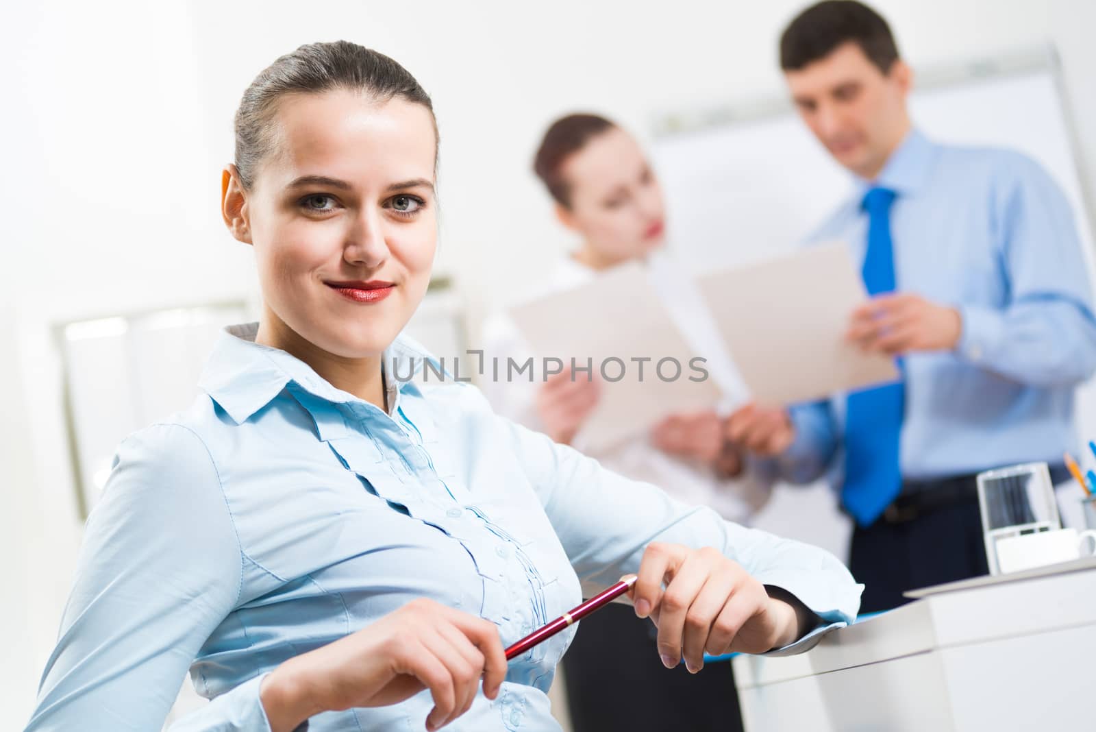 portrait of a business woman in office, smiling and looking into the camera, office work