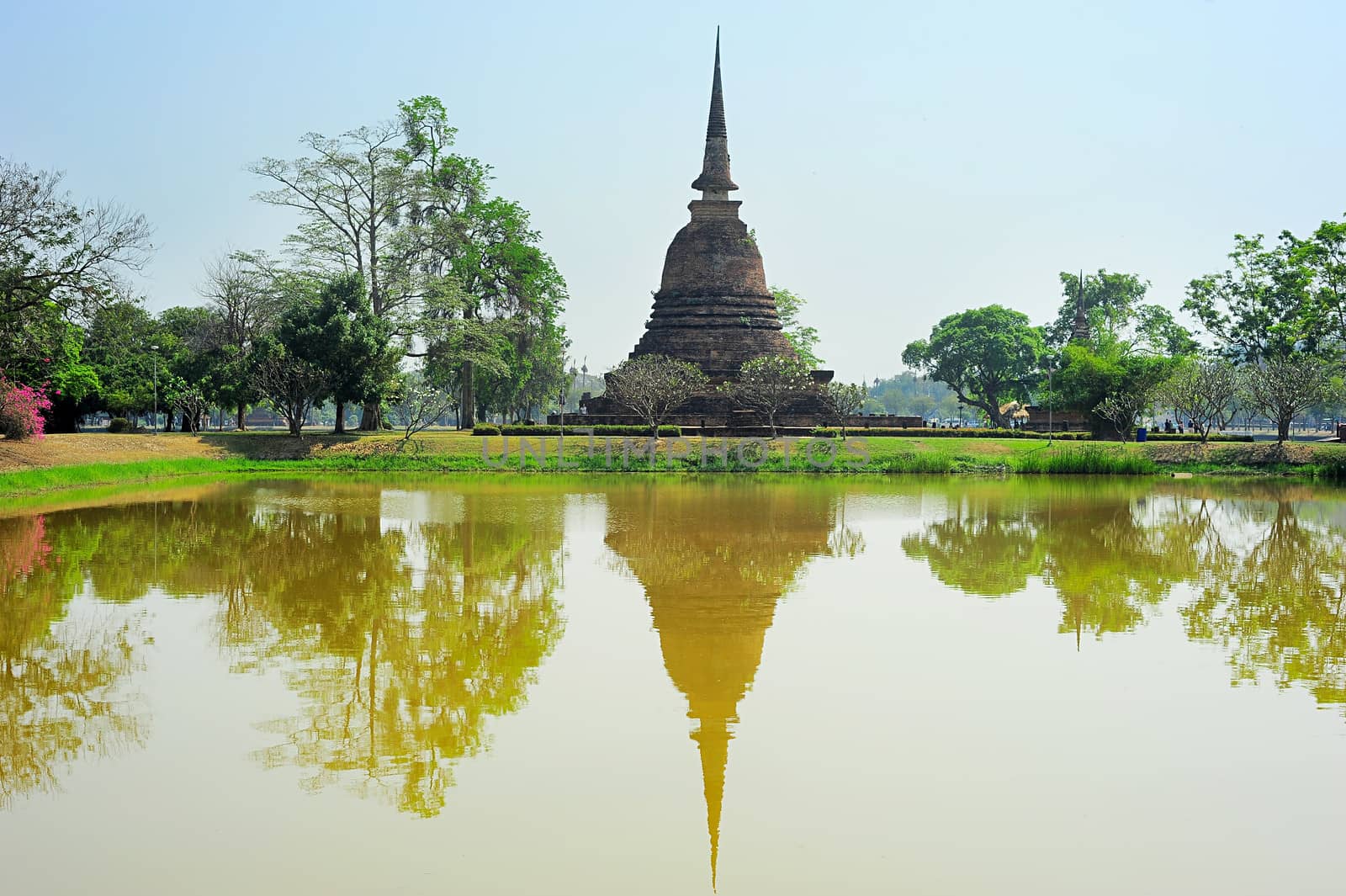 Pagoda reflected in the pond at  Sukhothai Historical Park . Thailand