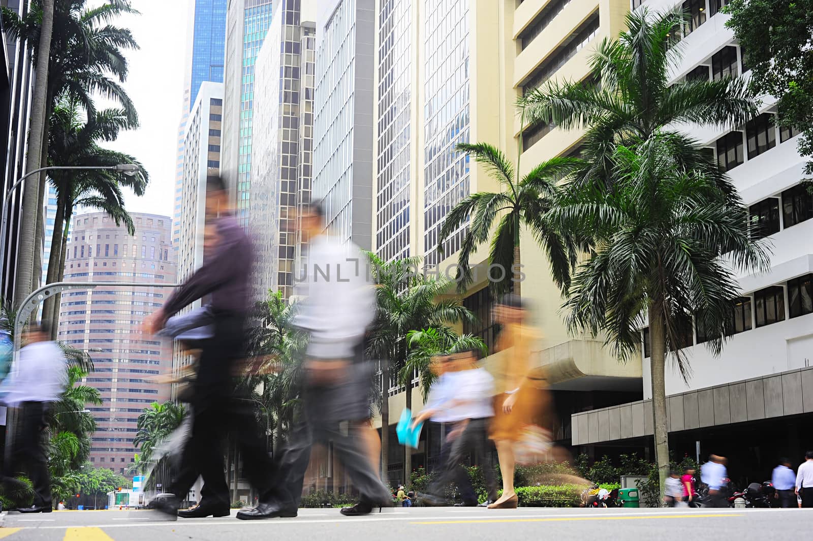 Unidentified businessmen crossing the street in Singapore. There are more than 7,000 multinational corporations from US States, Japan and Europe in Singapore 