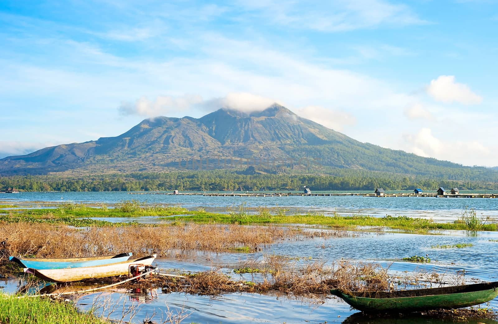 Fishing boats in front of volcano Batur at sunset