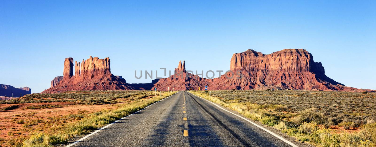 panoramic view of long road at Monument Valley, USA