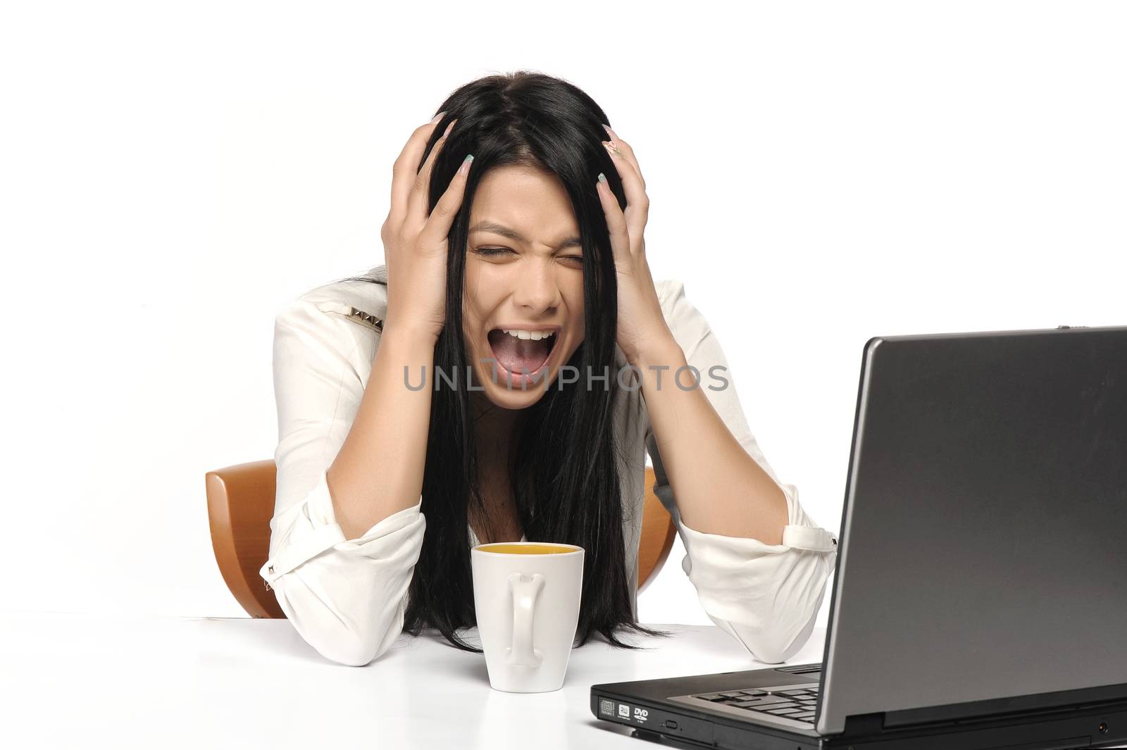 Woman screaming nervously at the laptop isolated on white. 
