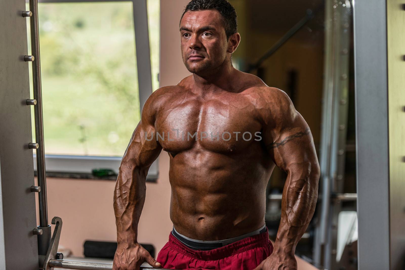 male bodybuilder doing heavy weight exercise for trap