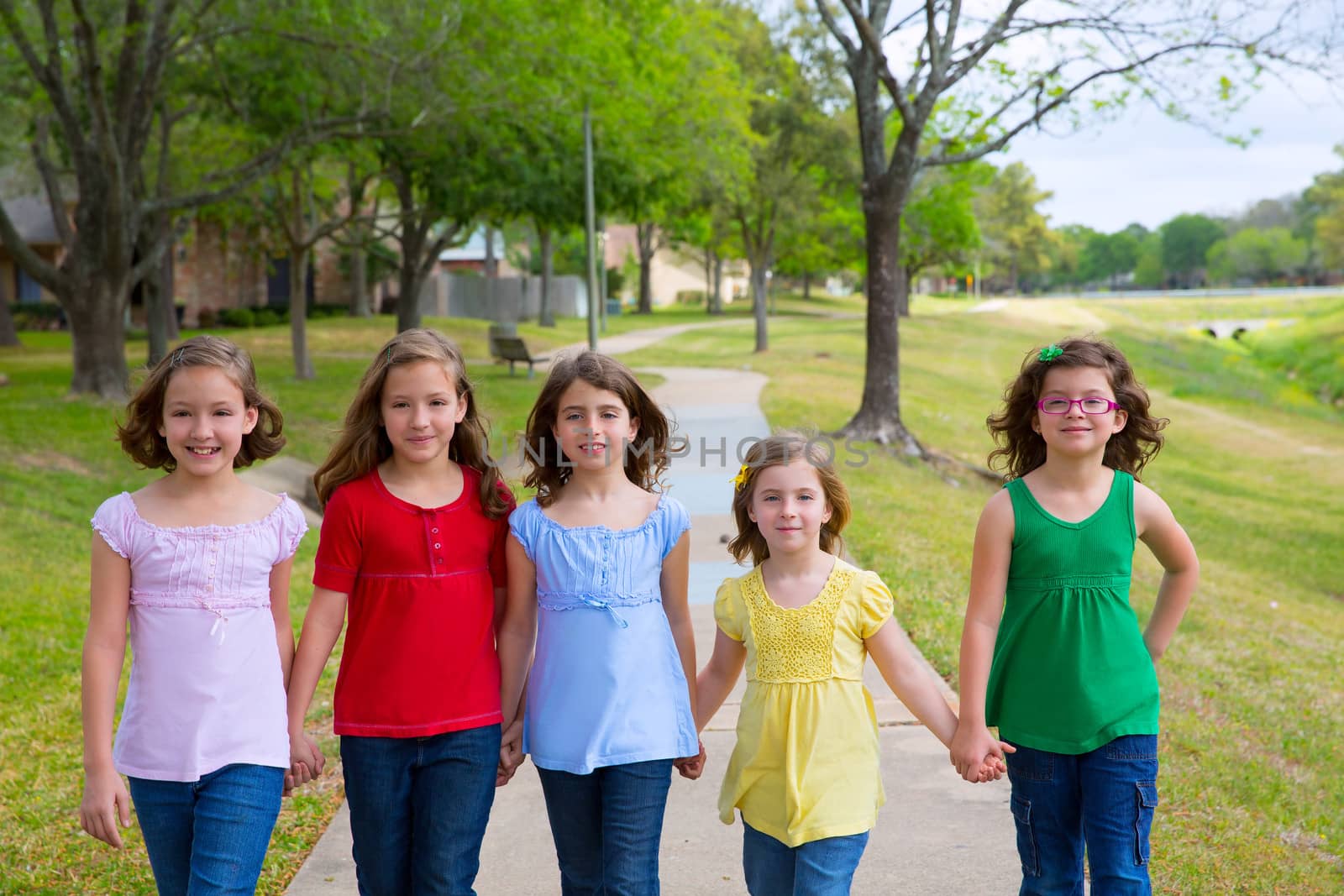 Children group of sisters girls and friends walking in park by lunamarina