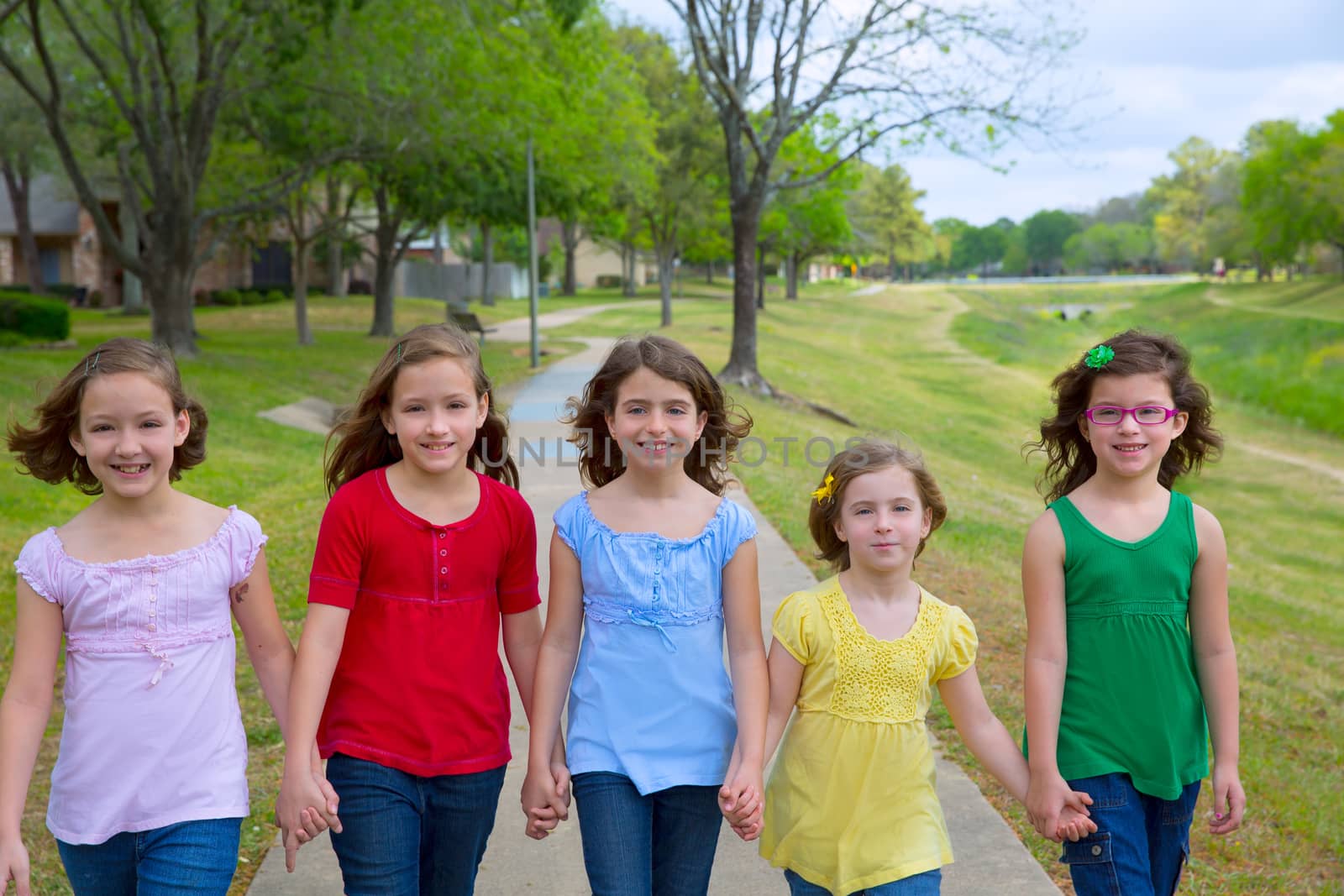 Children group of sisters girls and friends walking in park by lunamarina