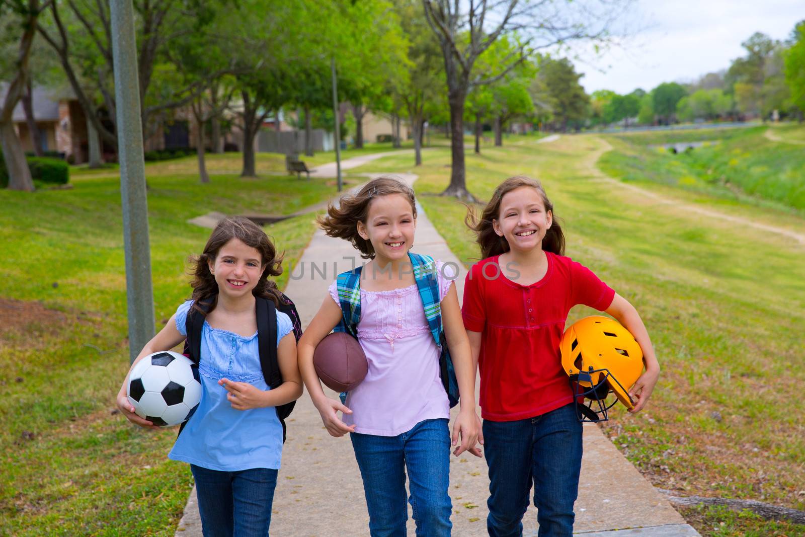 Children kid girls walking to schoool with sport balls by lunamarina