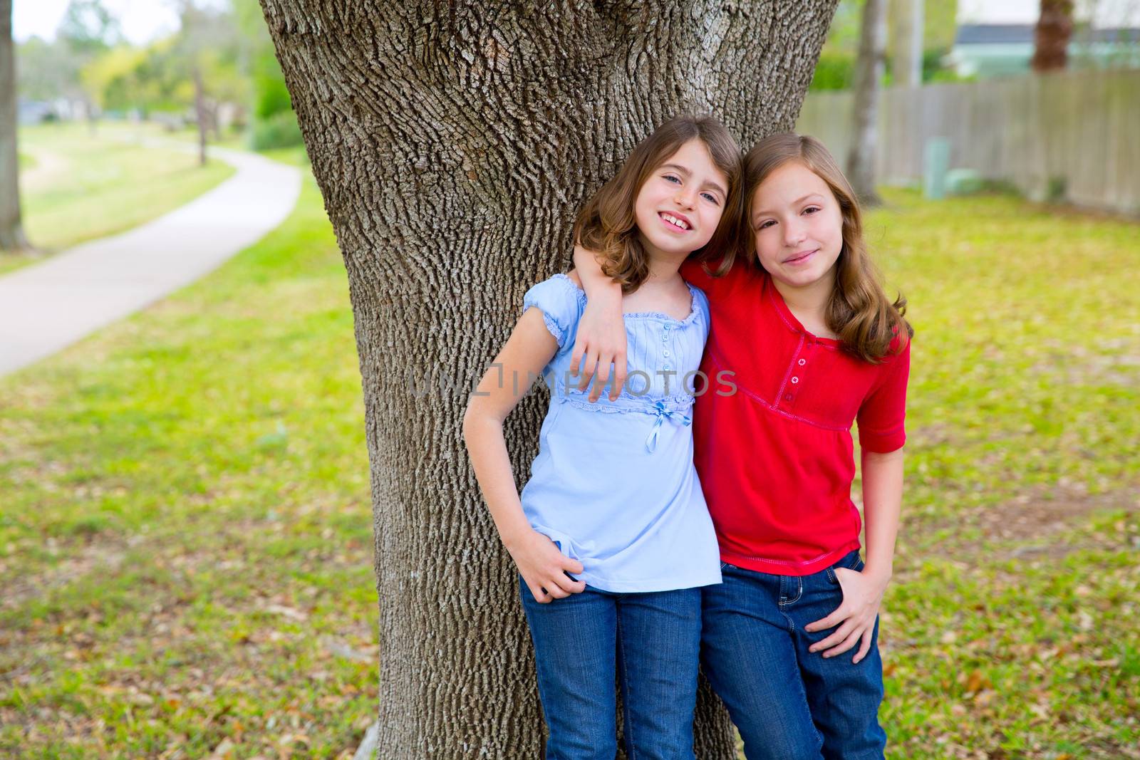 children kid friend girls hug relaxed happy smiling in a park tree outdoor