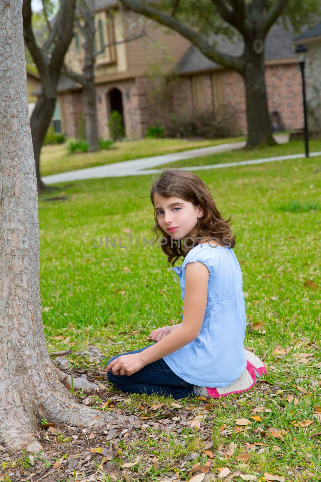 beautiful kid girl smiling sitting on park lawn relaxed outdoor