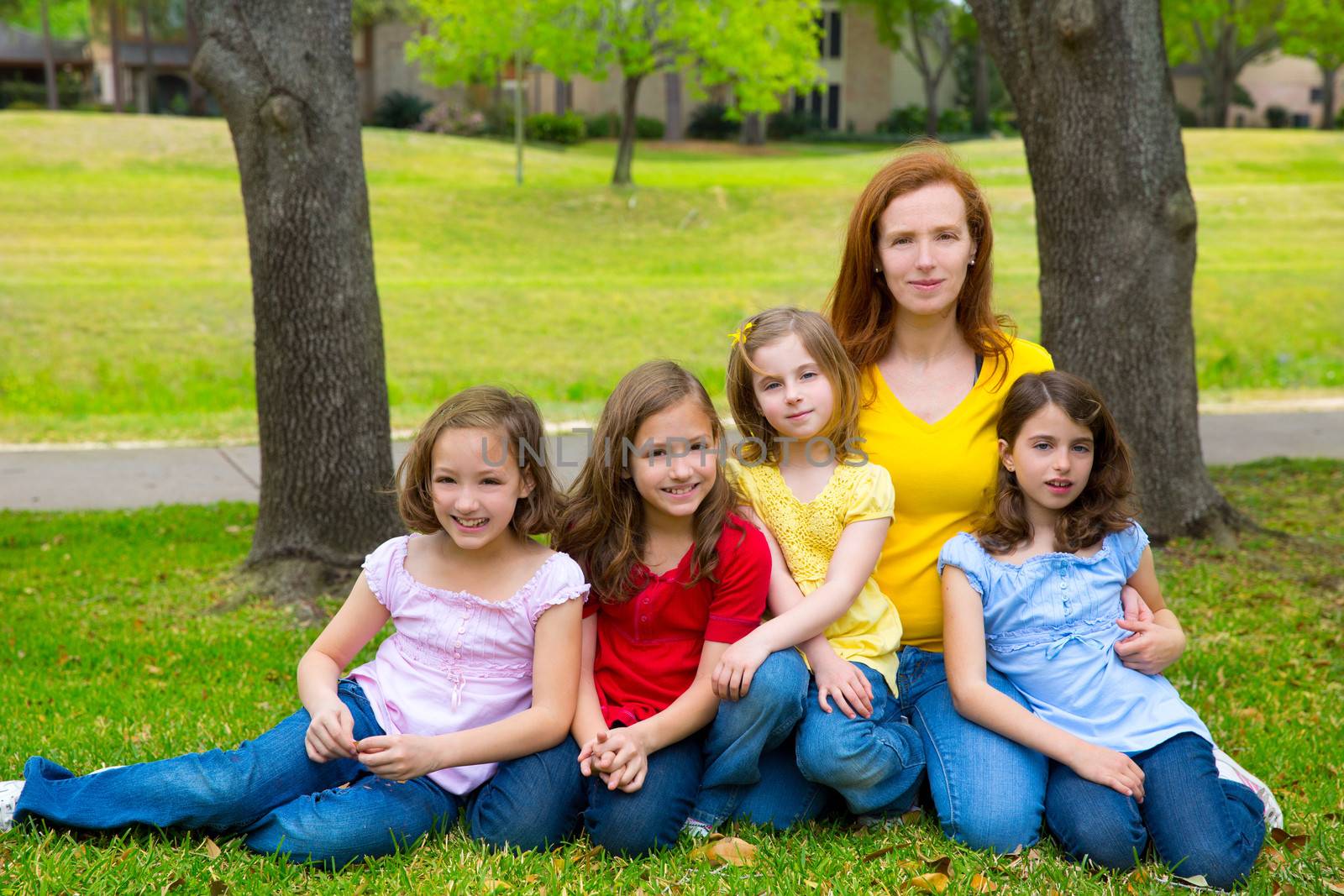 Mother teacher with daughter pupils in playground park by lunamarina