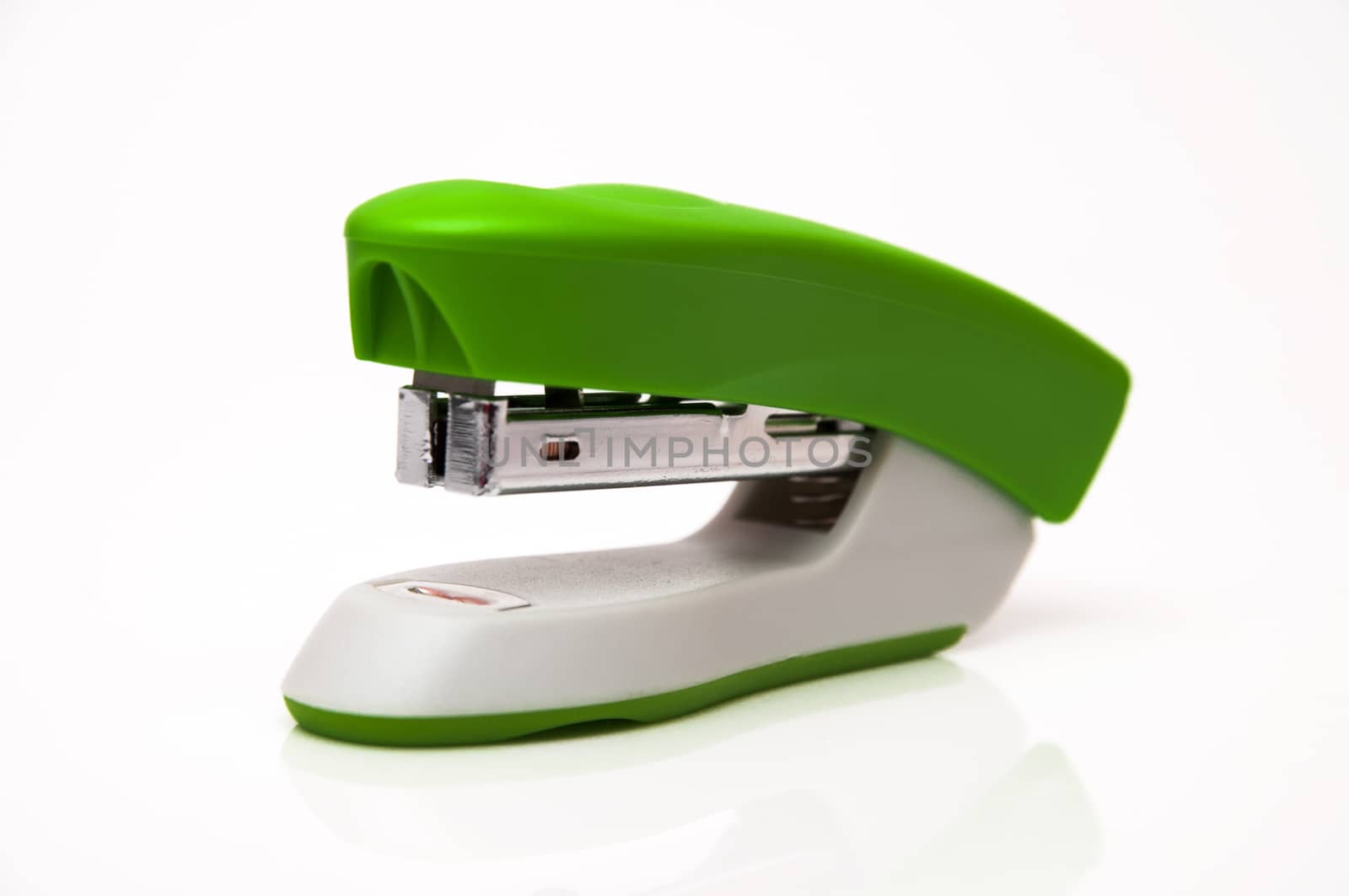 green stapler on a white background