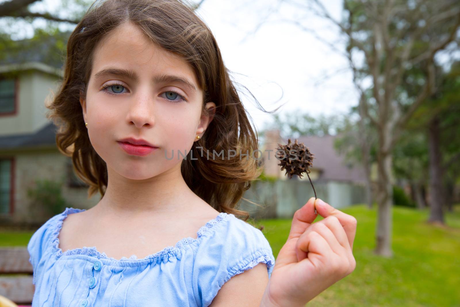 girl portrait with sweetgum spiked fruit on park by lunamarina