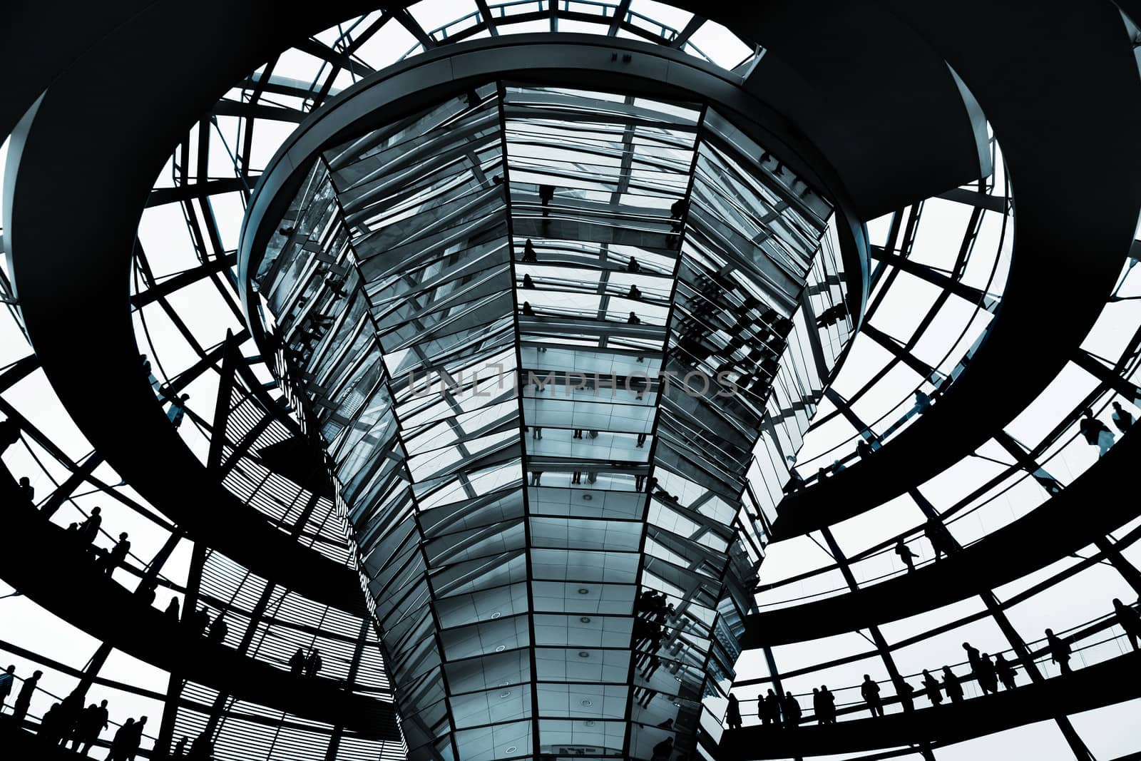 People move on a spiral ramp in a glass dome of the Reichstag, Berlin