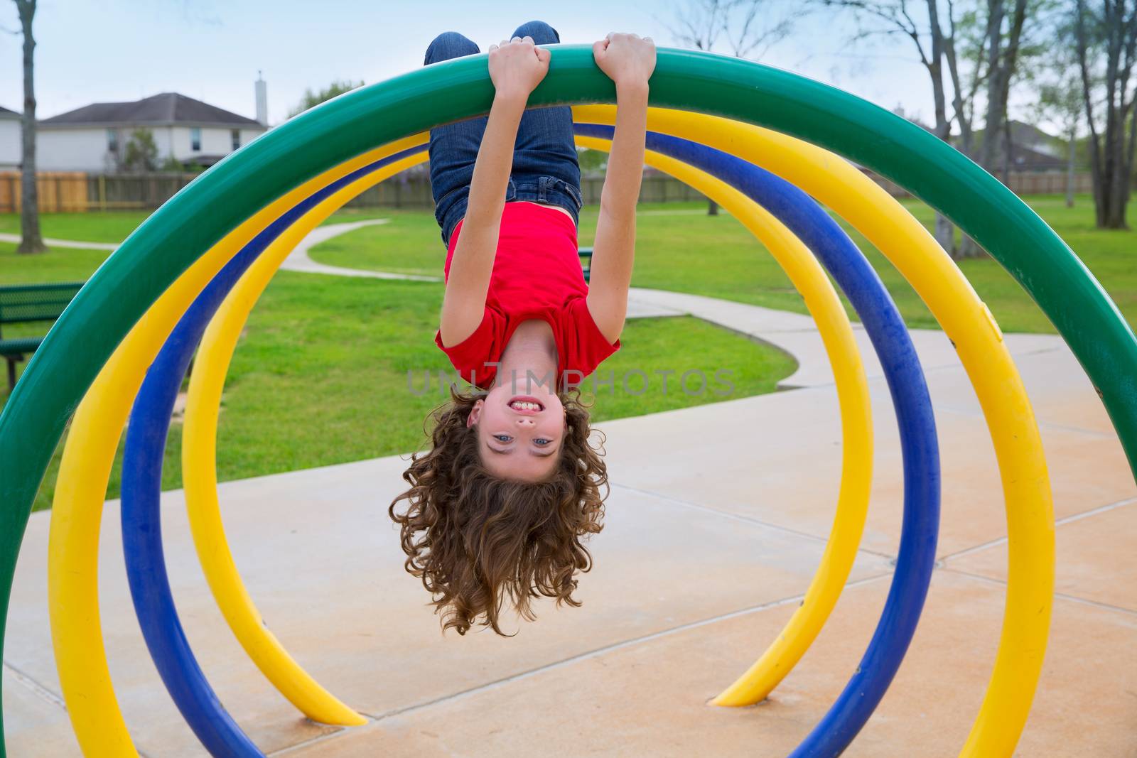 children kid girl upside down on a park ring by lunamarina