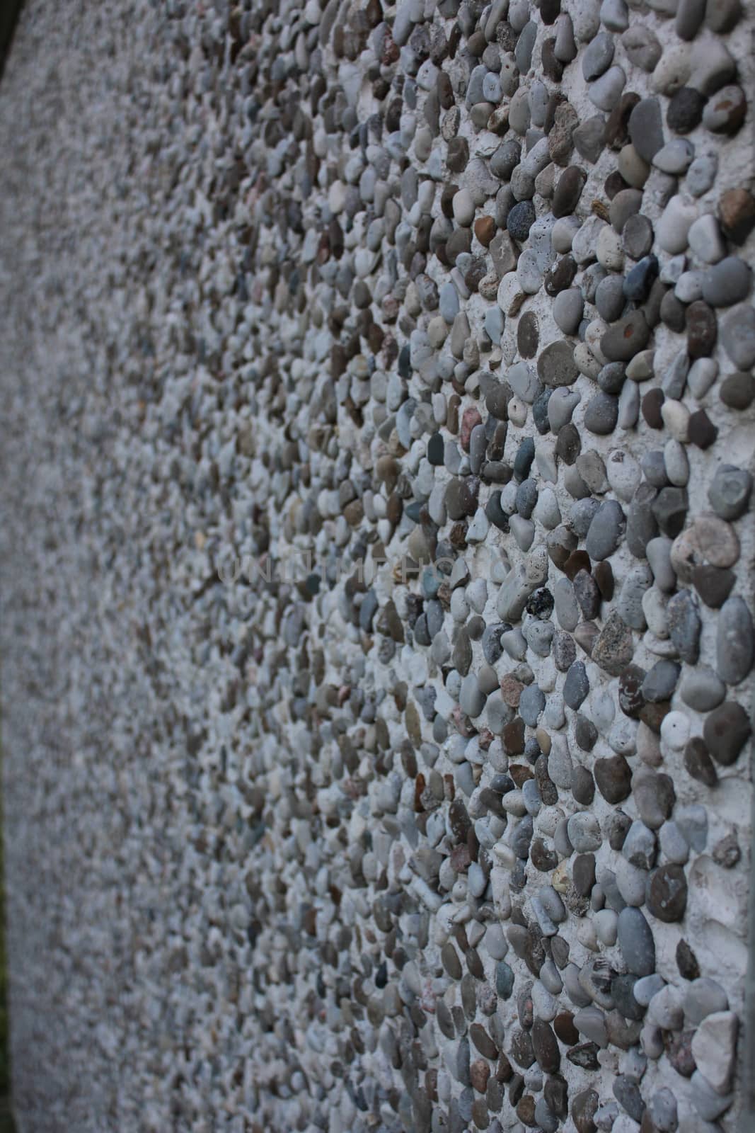 A pebbled wall face on an industrial building
