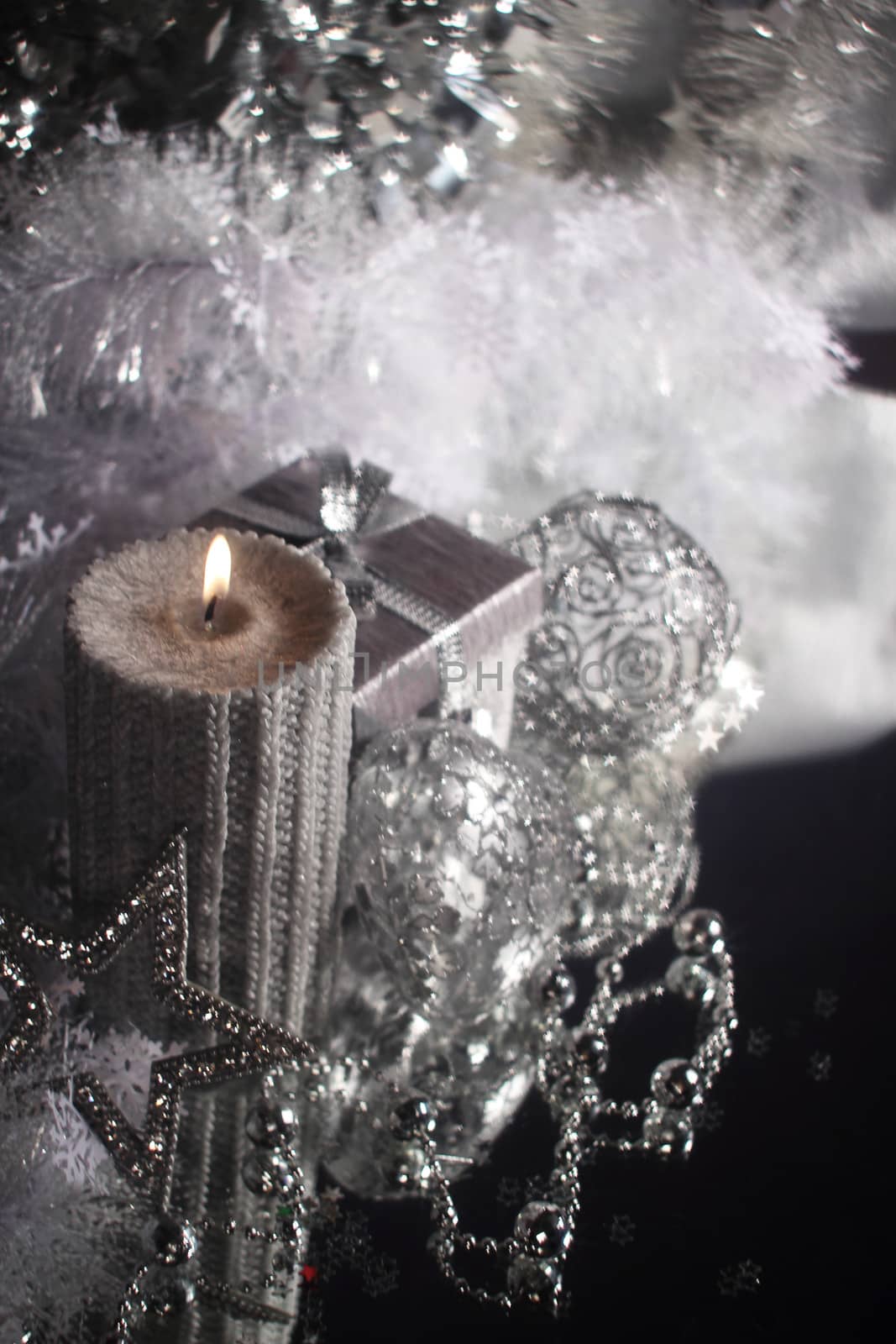 Christmas candle with gift and different silver decoration