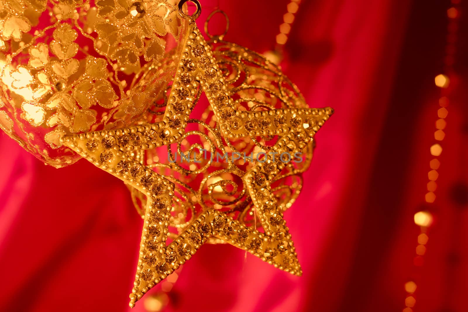 Golden christmas decoration on red fabric background