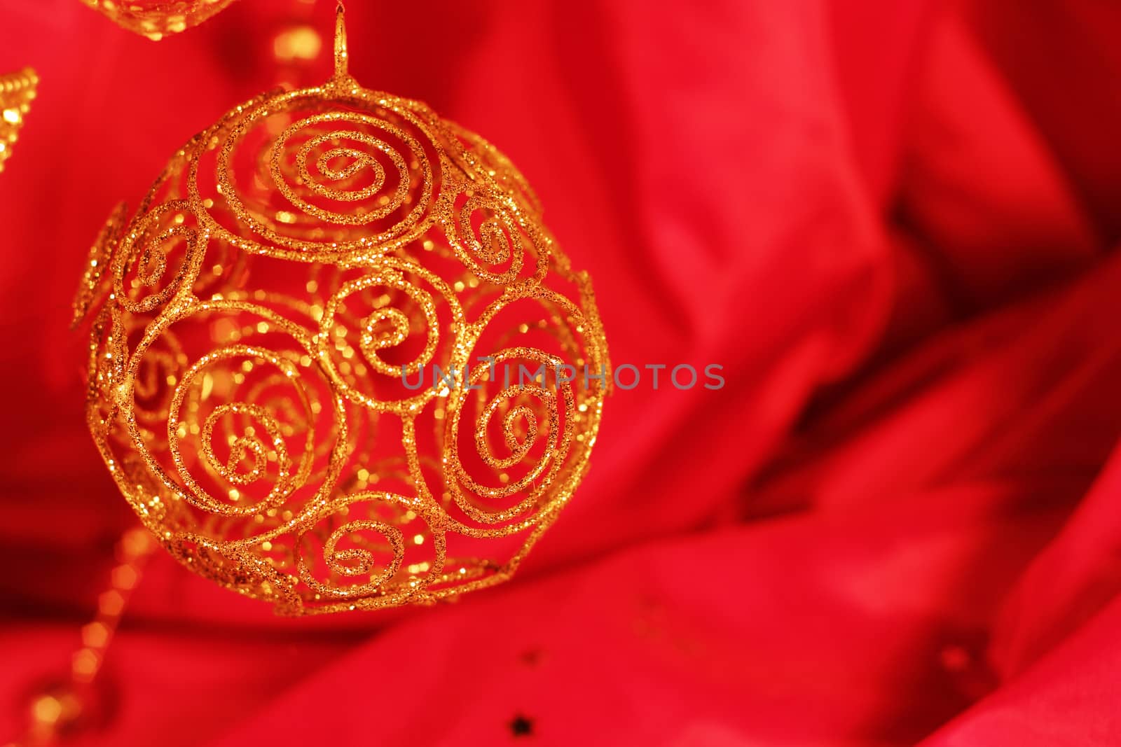 Golden christmas decoration on red fabric background