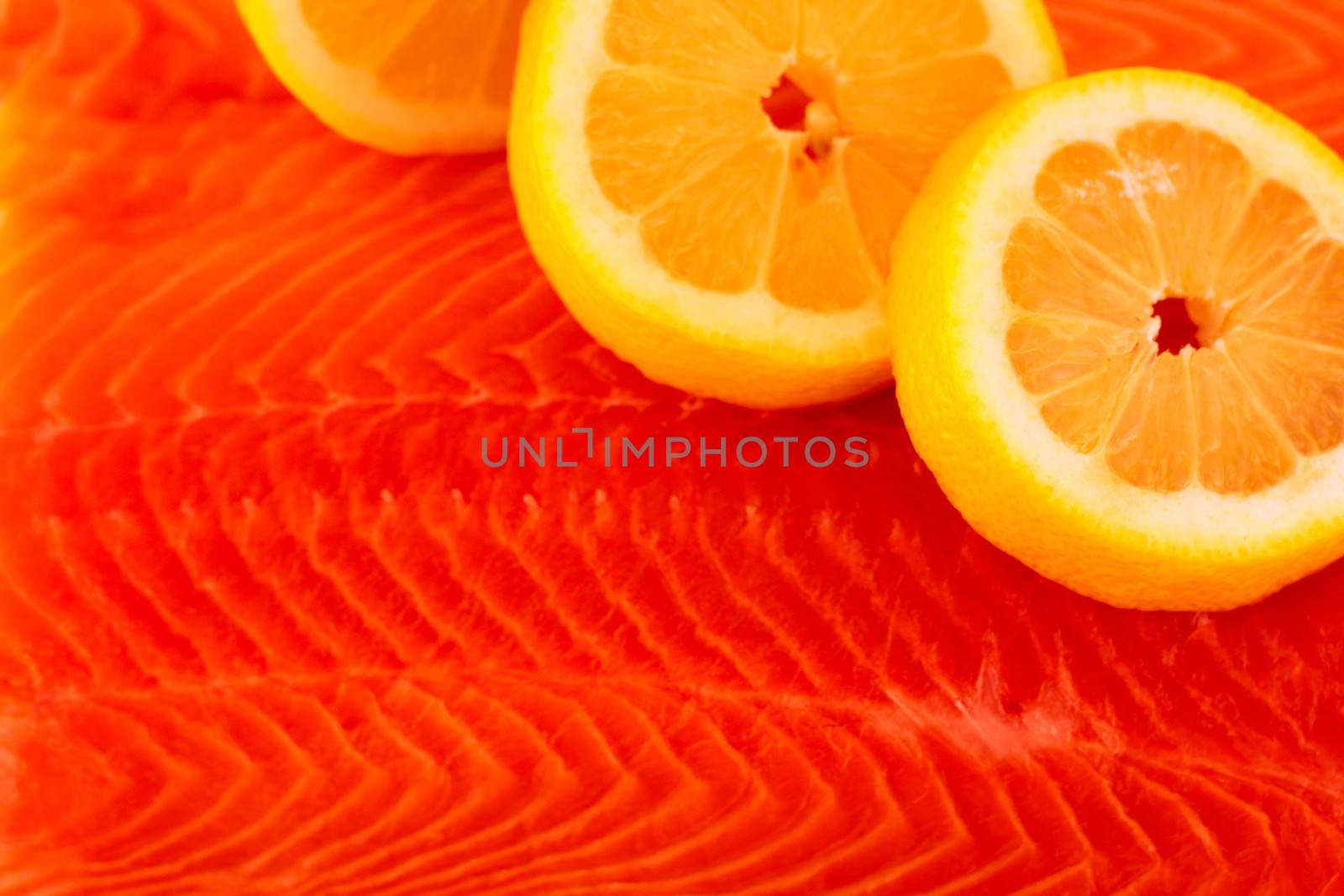 Salmon red fish texture with lemon closeup background