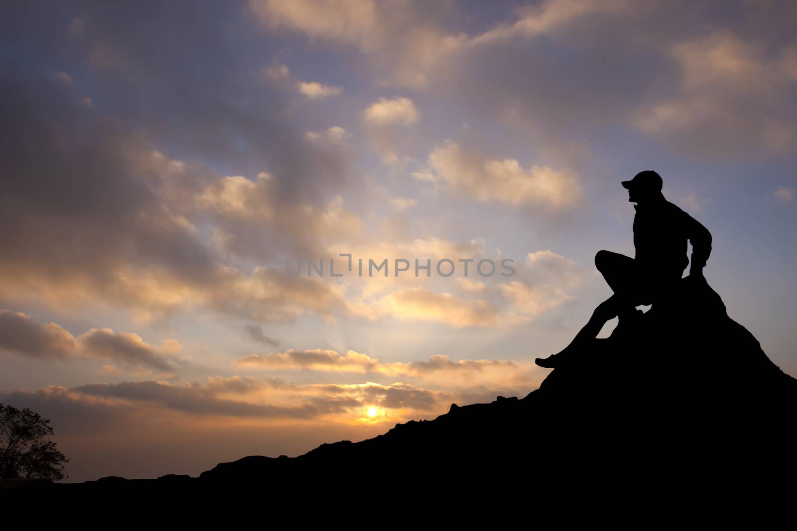 Silhouette of a man on mountain by tanatat