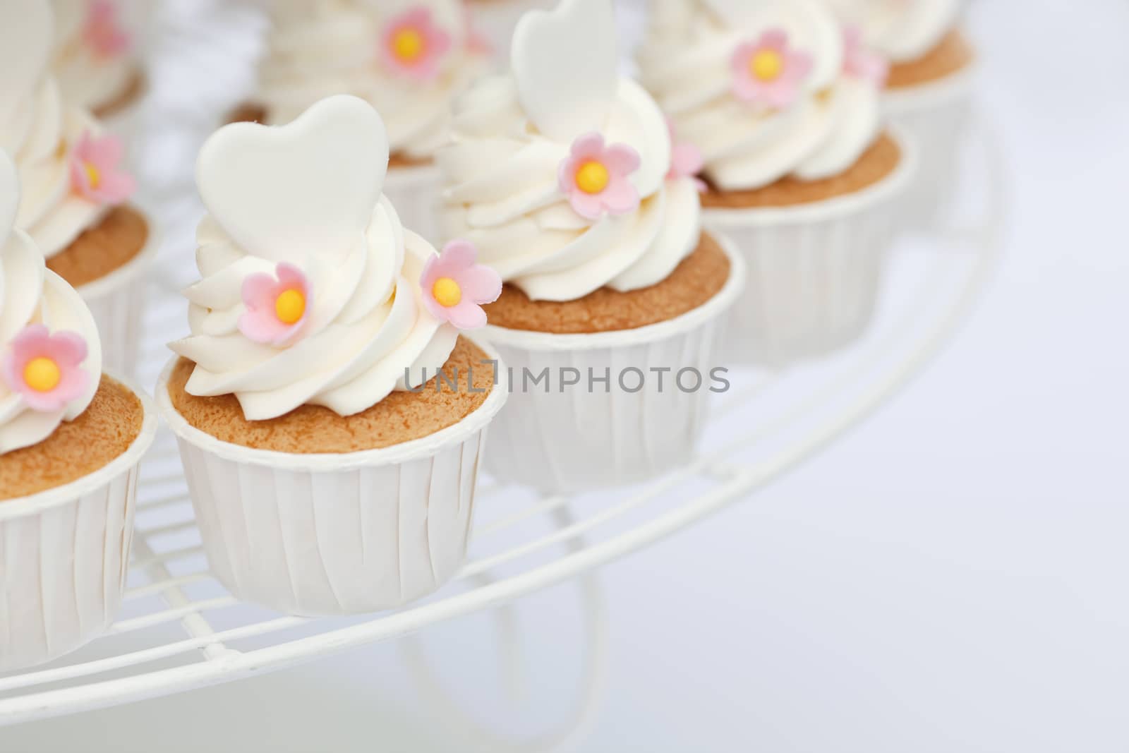 Heart shape decoration on cupcakes with shallow focus