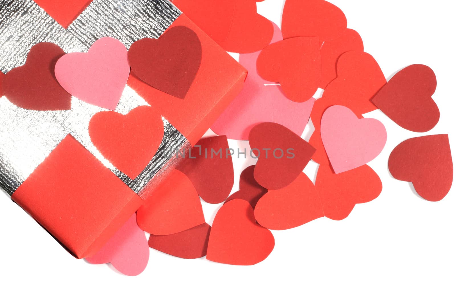 Valentines Day gift in red box and small hearts isolated on white top view