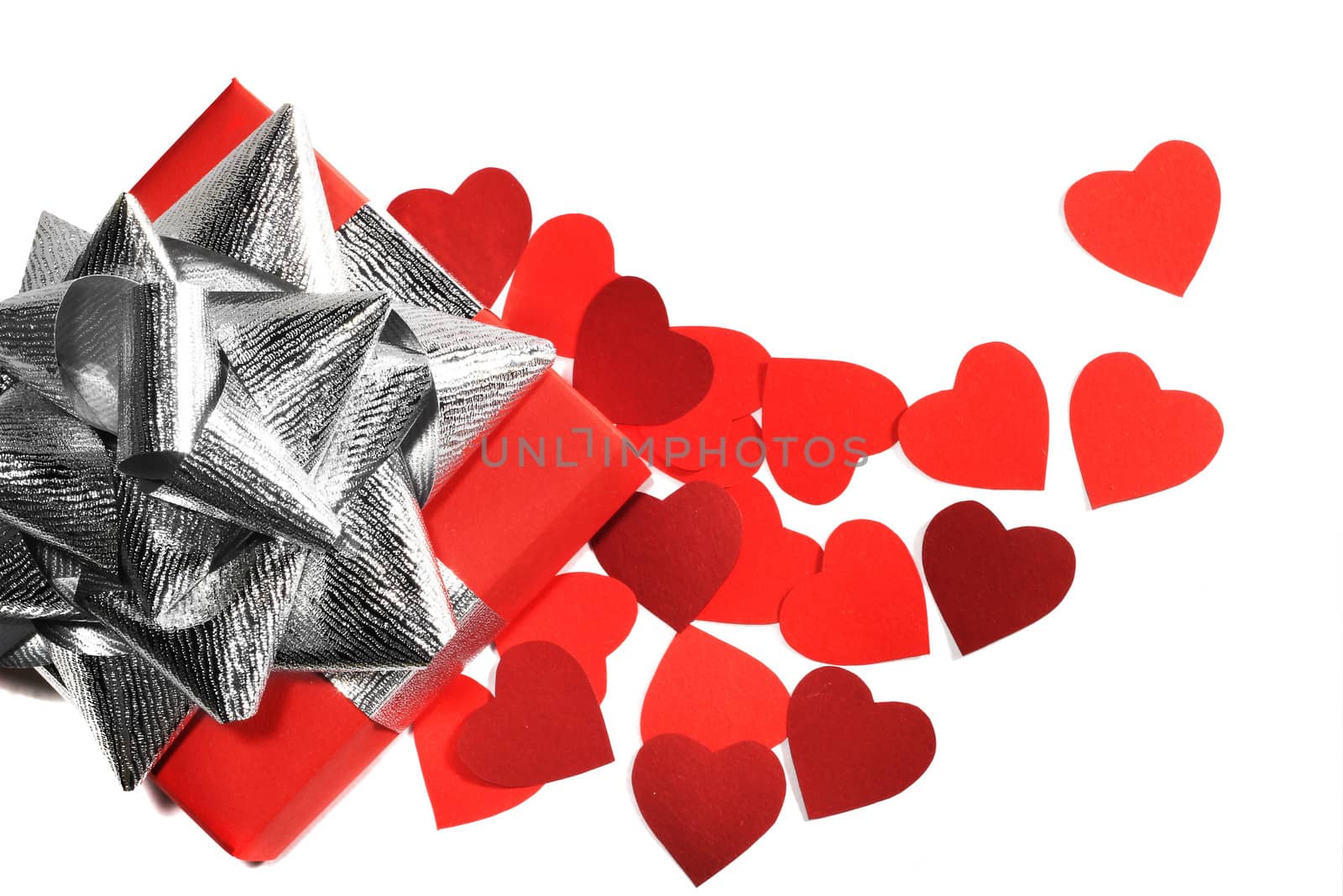 Valentines Day gift in red box and small hearts isolated on white top view