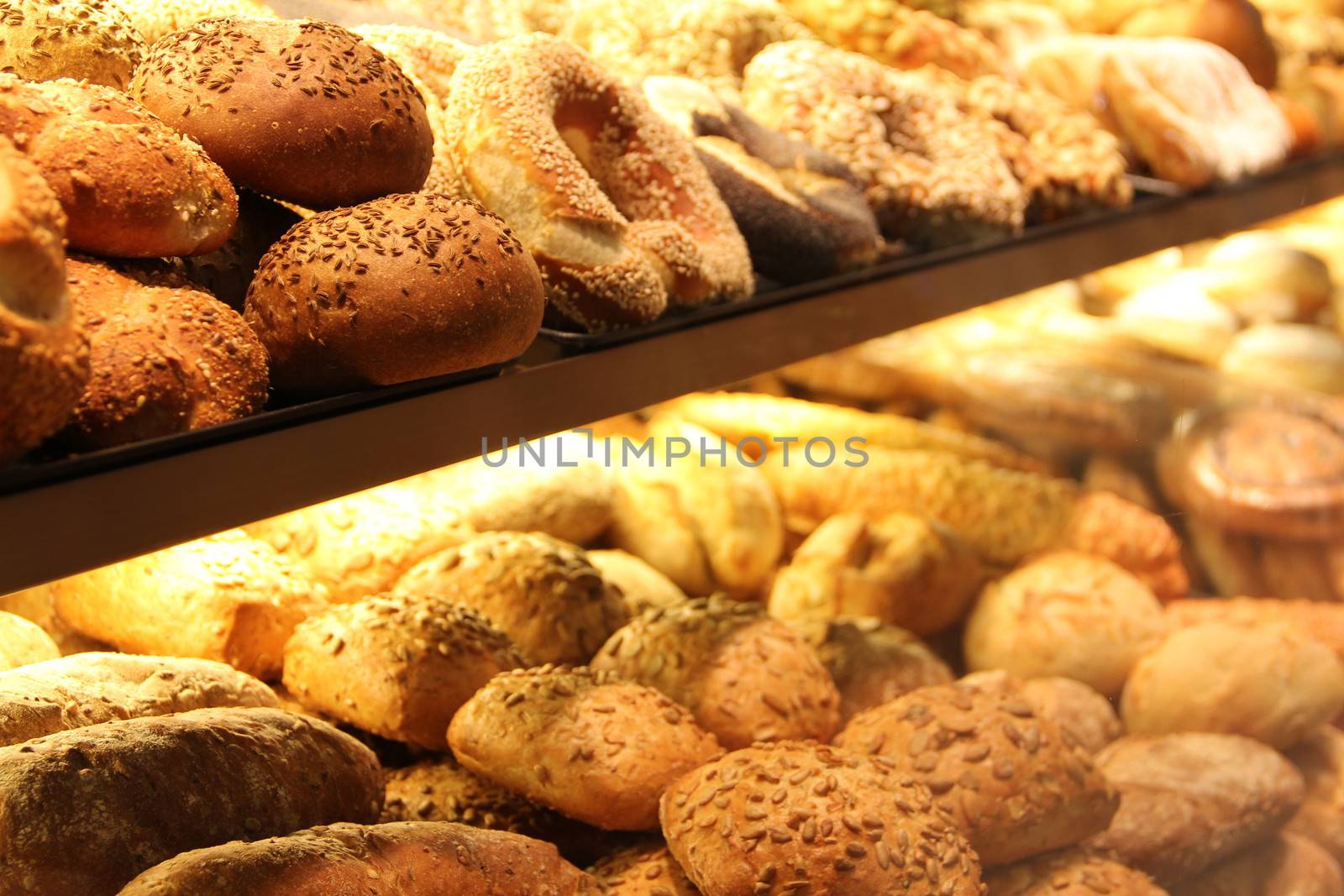 different appetizing bread on showcase in supermarket