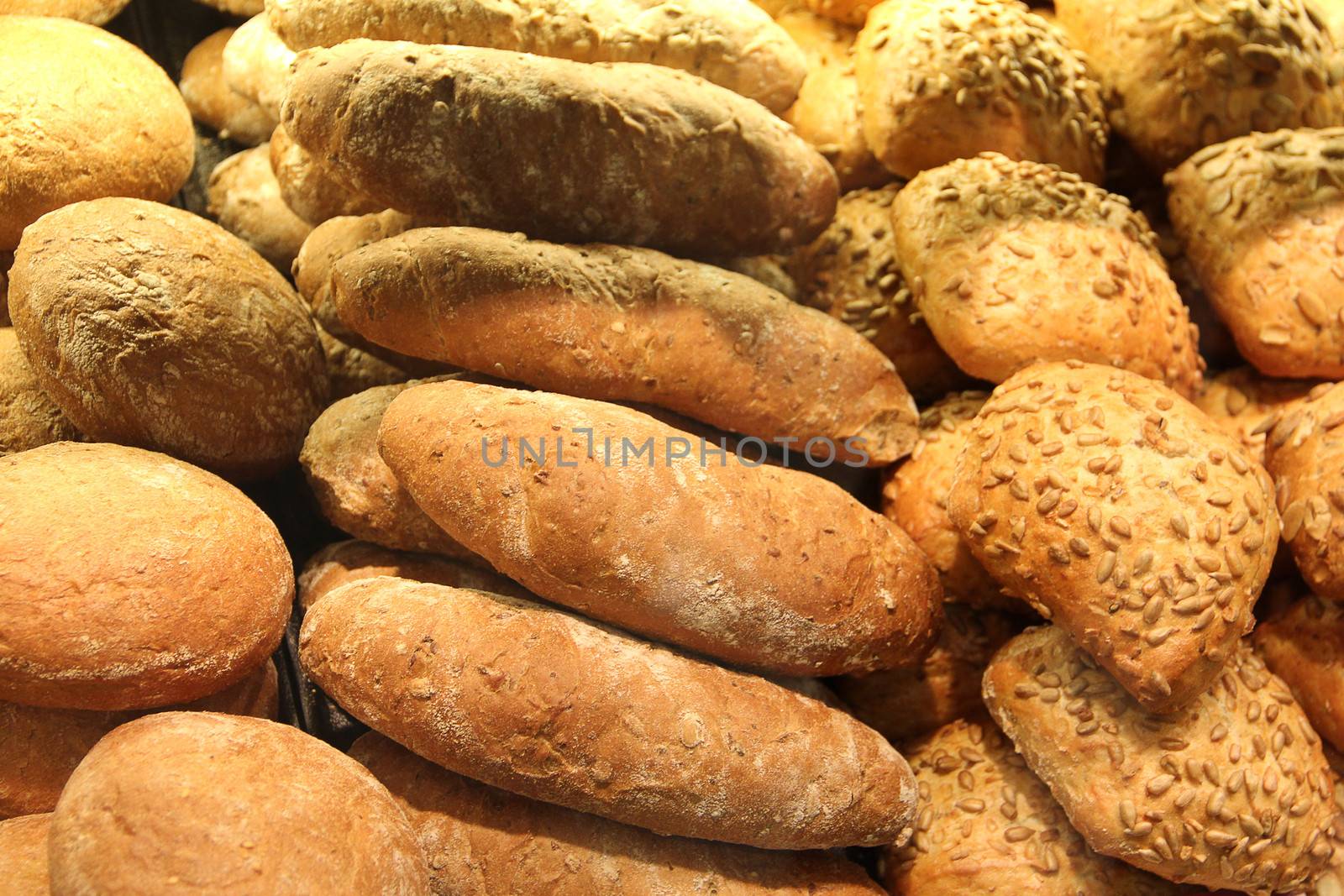 different appetizing bread on showcase in supermarket