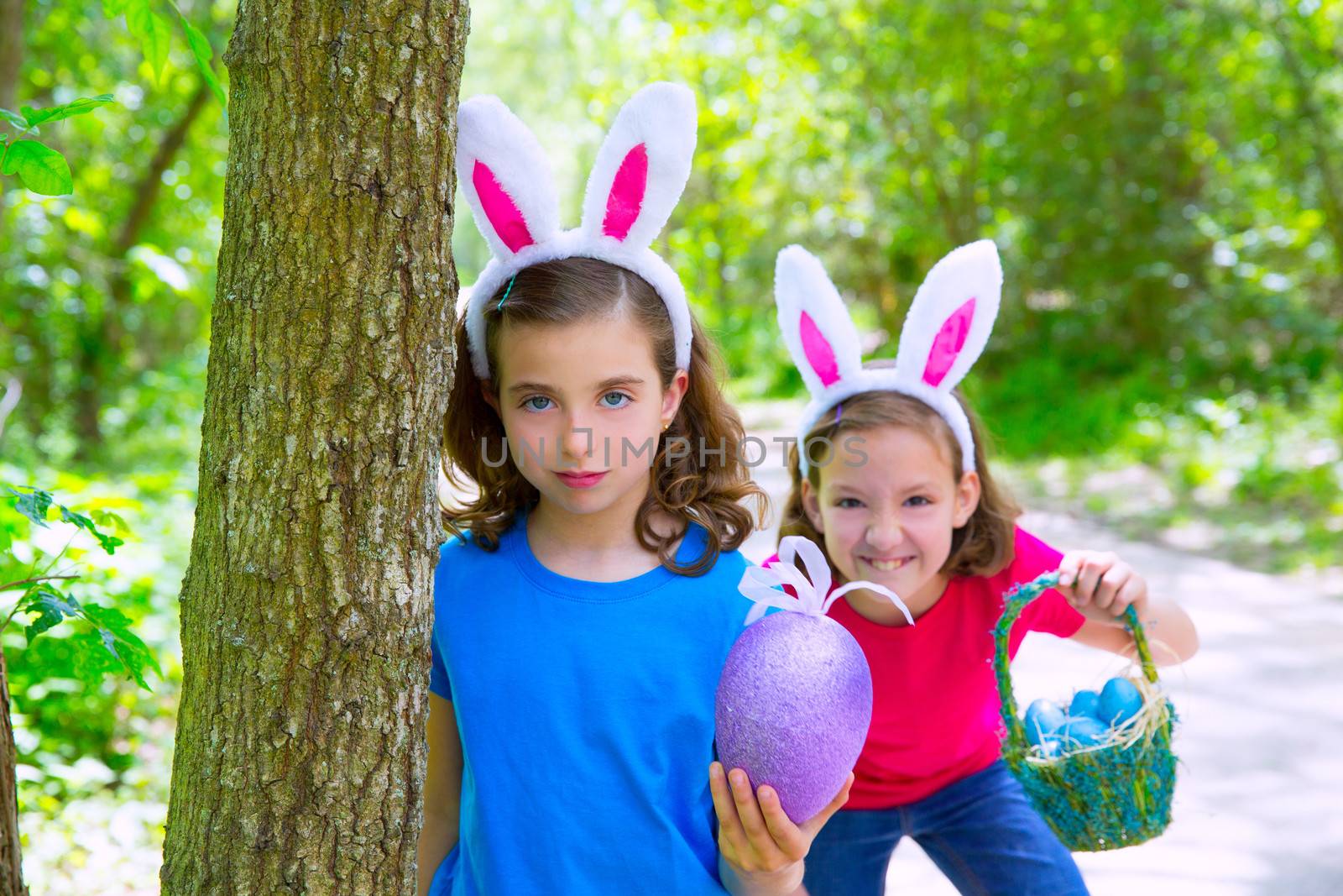 Easter girls playing on forest with bunny teeth expression outdoor