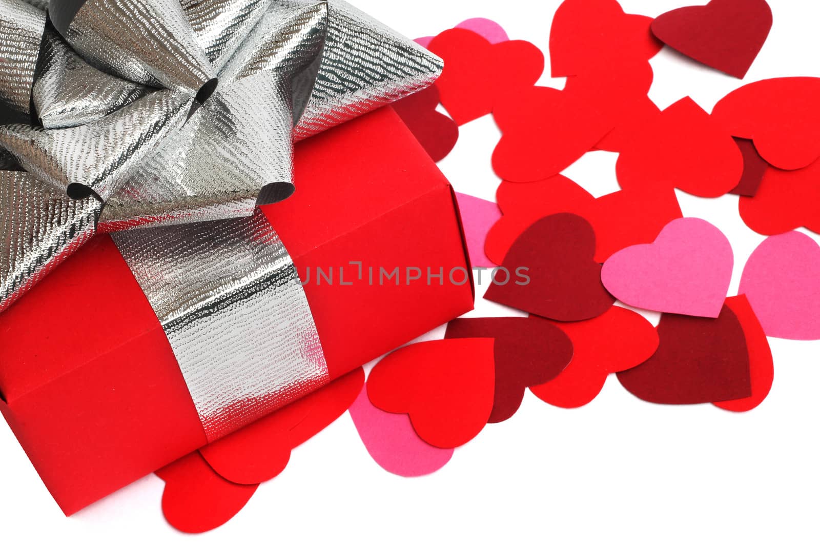 Valentines Day gift in red box and small hearts isolated on white